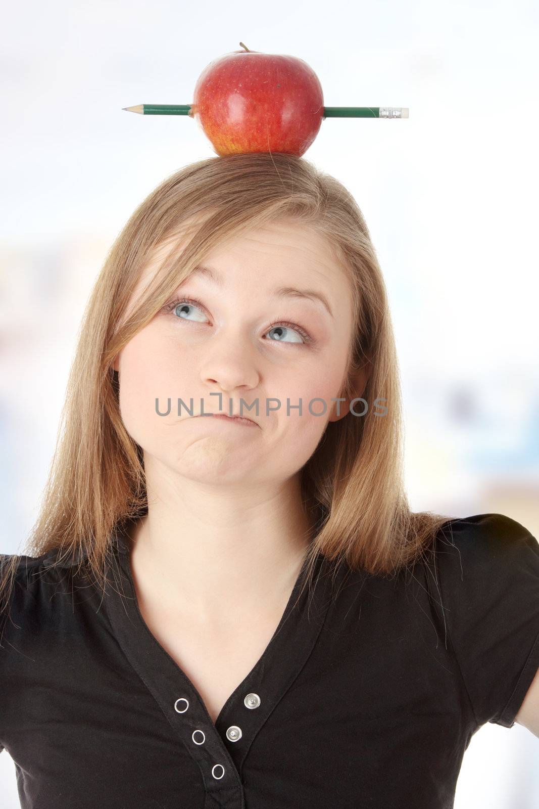 Beautiful student woman have one apple with pencil on her head - learning concept