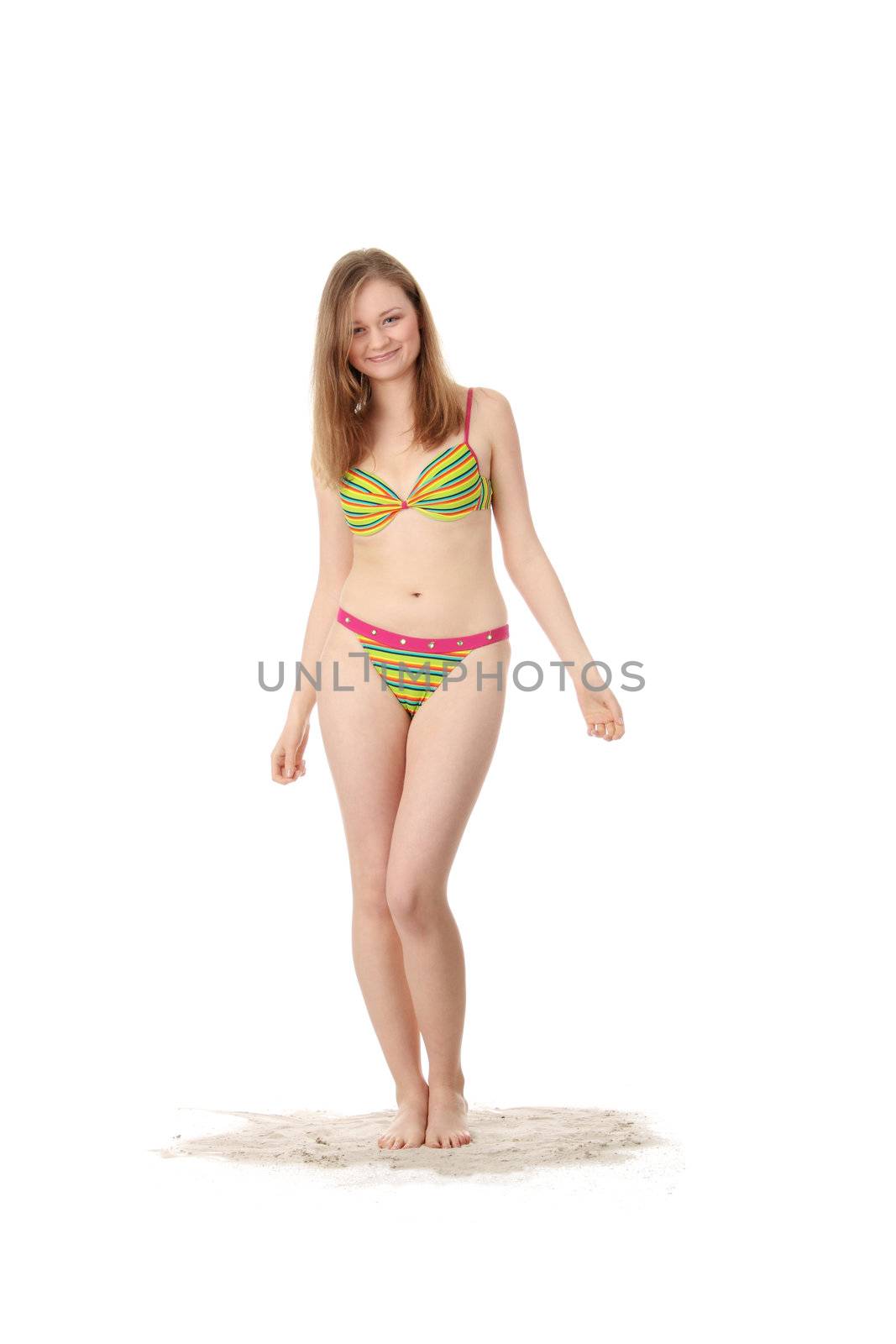 Summer girl standing on sand, isolated on white background
