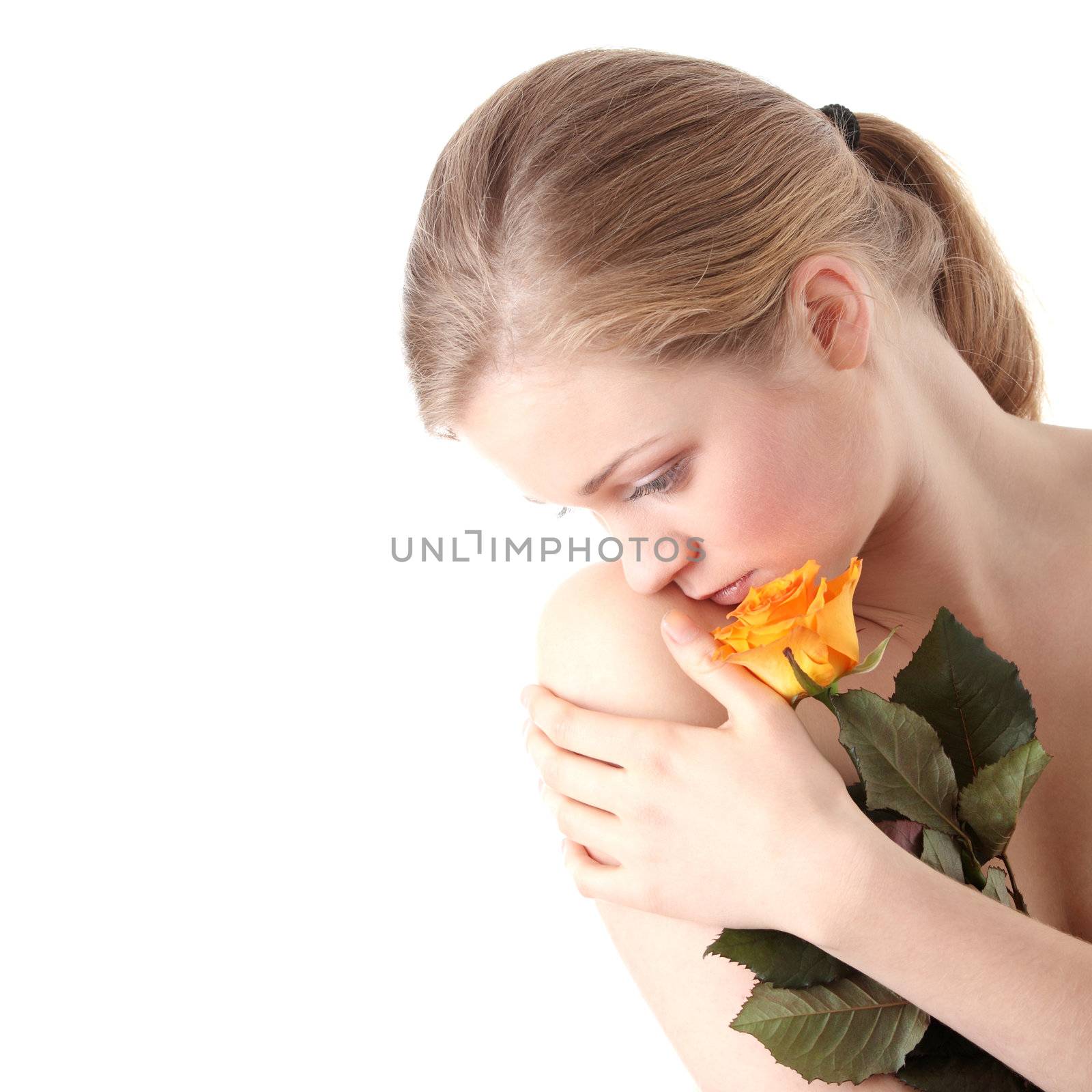 Sensual portrait of young nude sexy blond woman with orange rose
