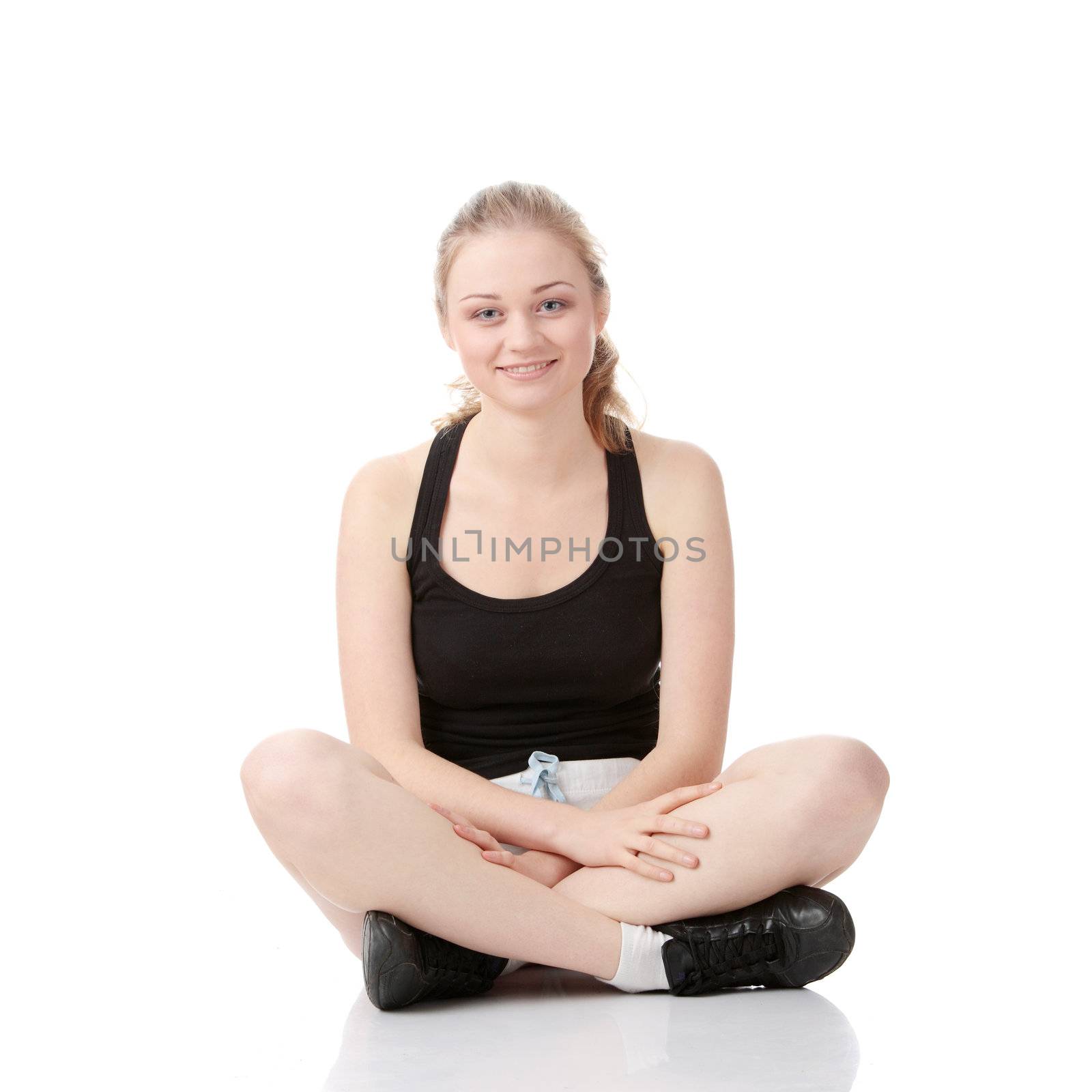 Beautiful young blonde exercising, isolated on white background