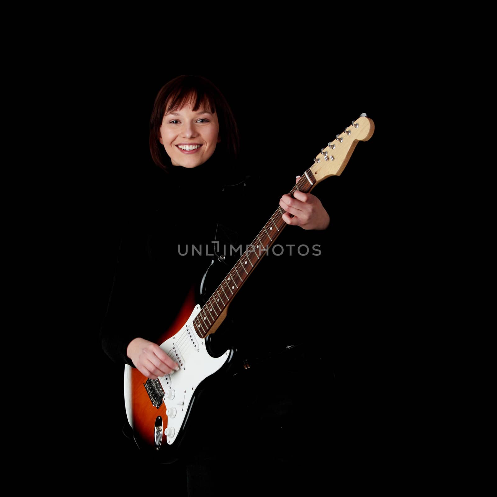 Woman with electric guitar, over black background