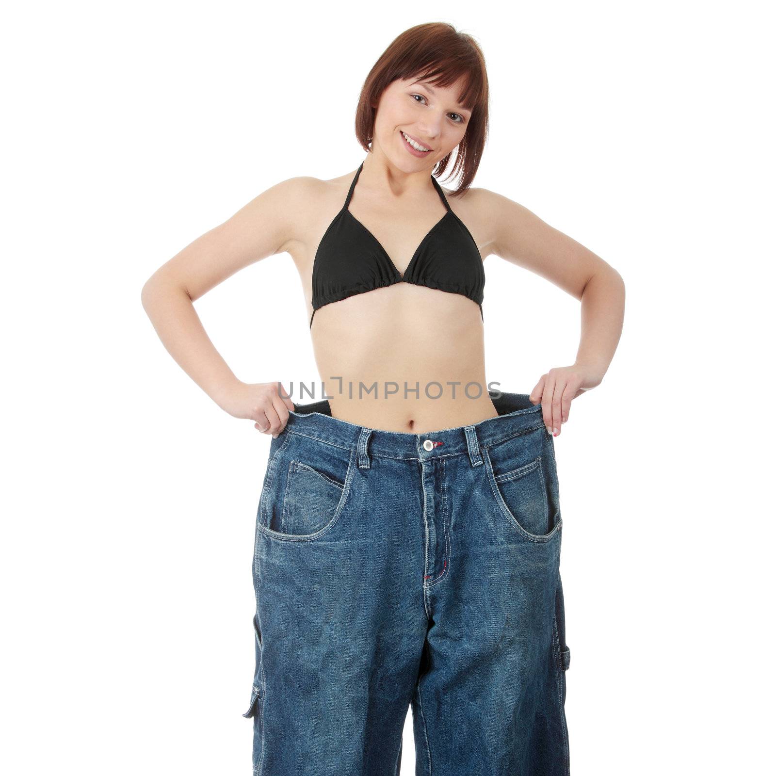 Teen woman showing how much weight she lost. Isolated on white