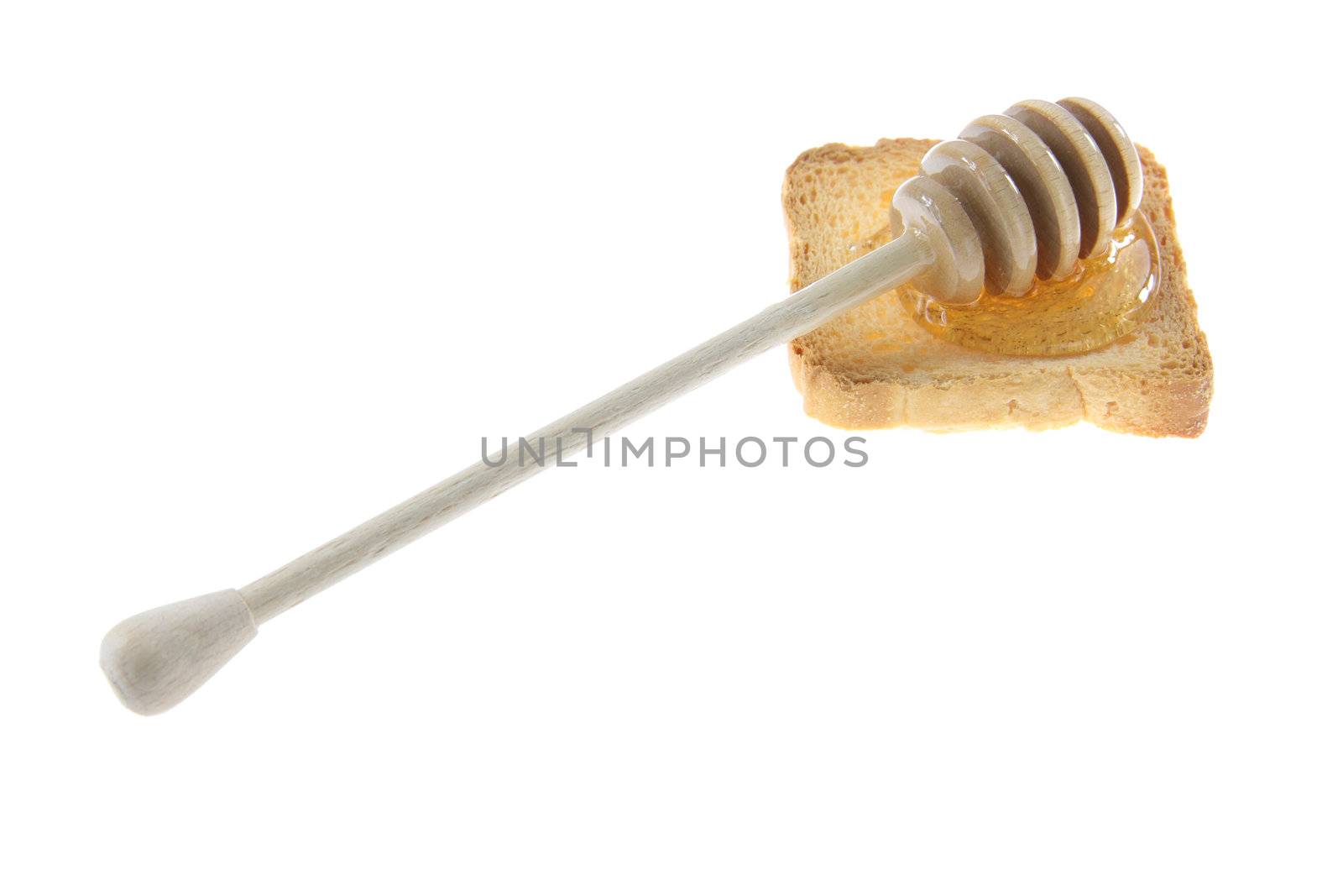 Wooden honey drizzler with a honey on bread - isolated on white.