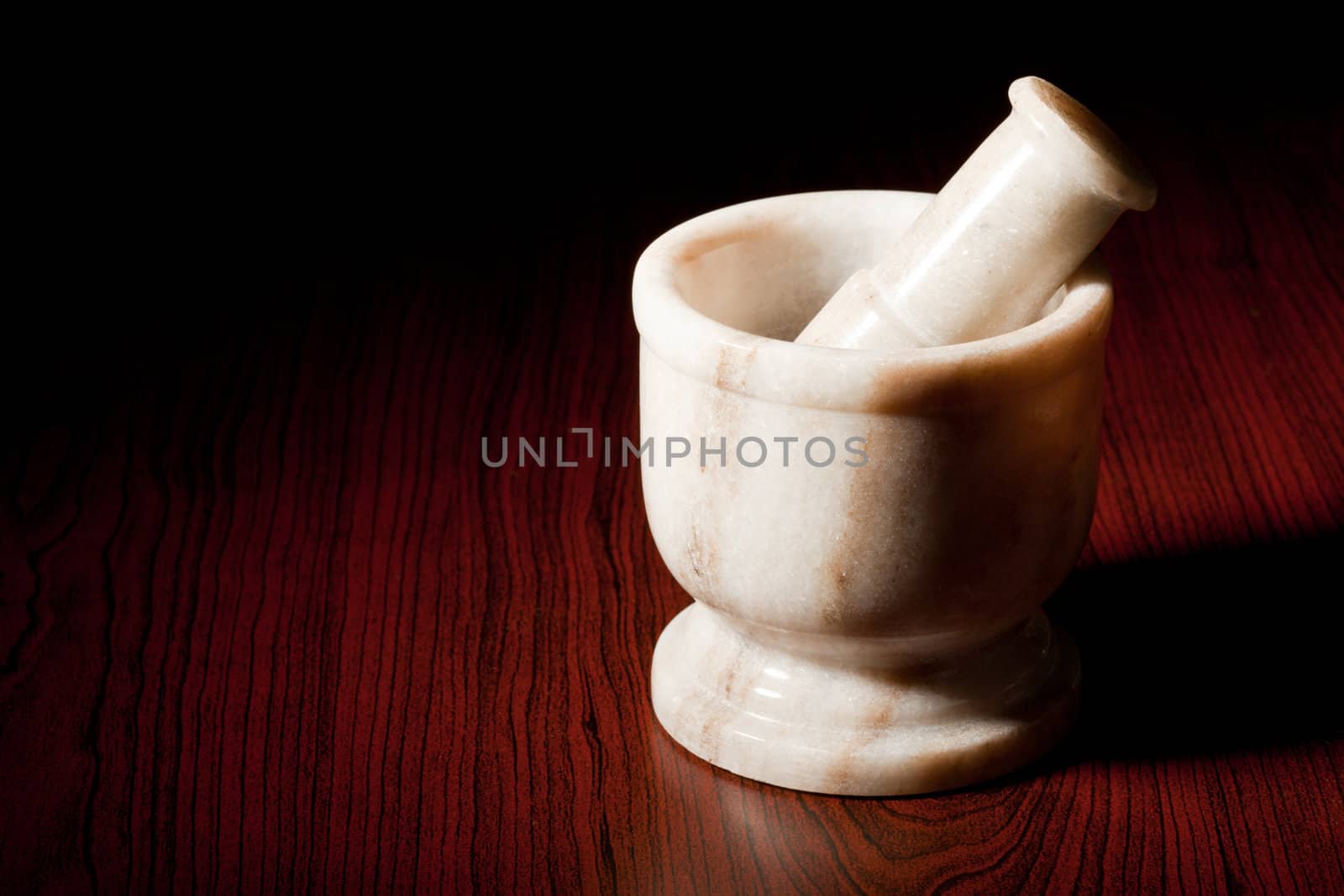Marble mortar and pestle on dark by dimol