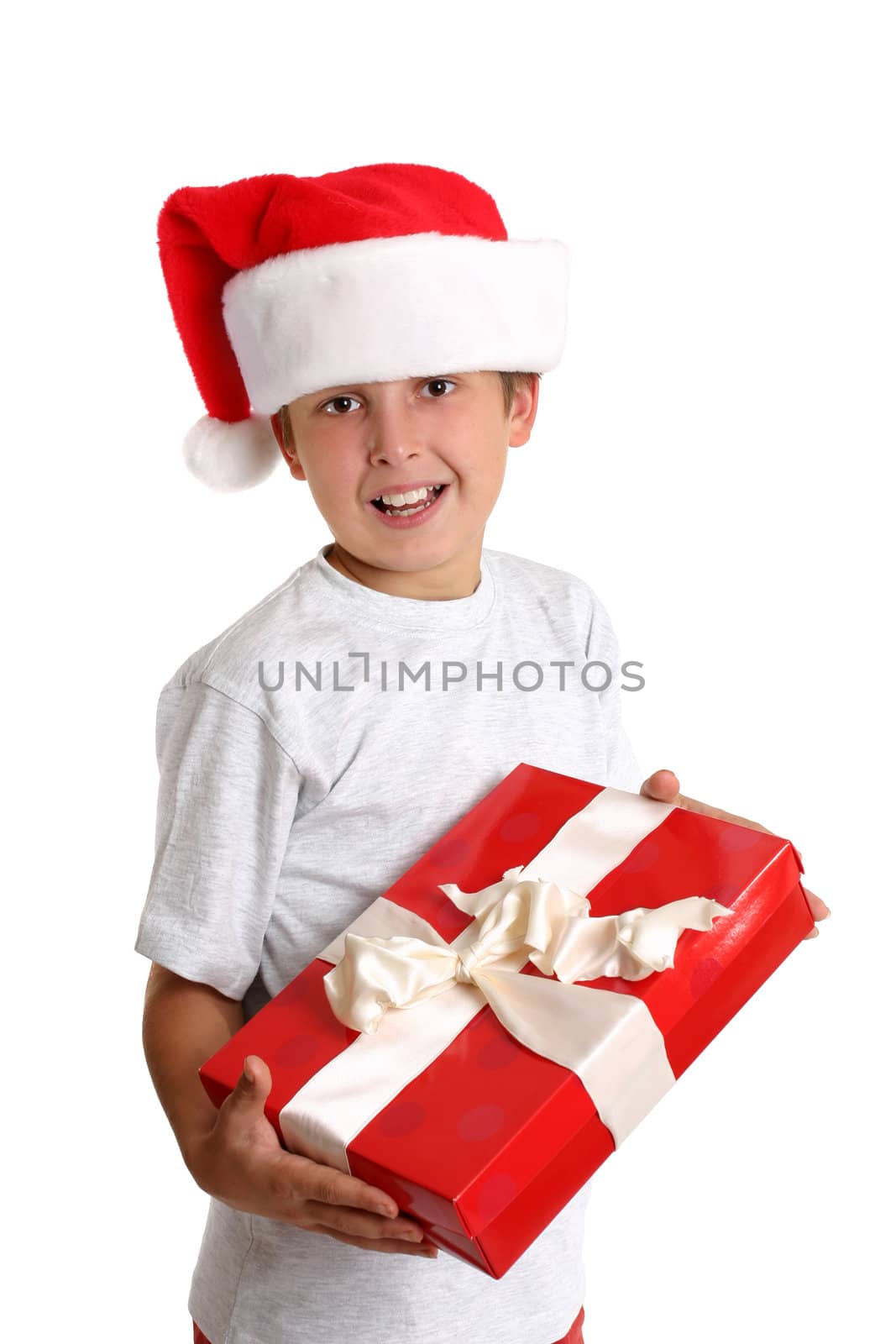 A happy you8ng child holding a gift tied with ribbon.  White background.