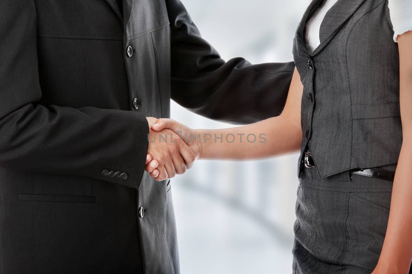 Young business couple handshaking
