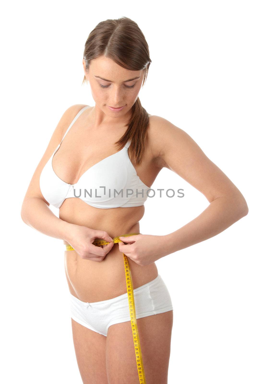 Yong caucasian woman measuring her waist, isolated on white background