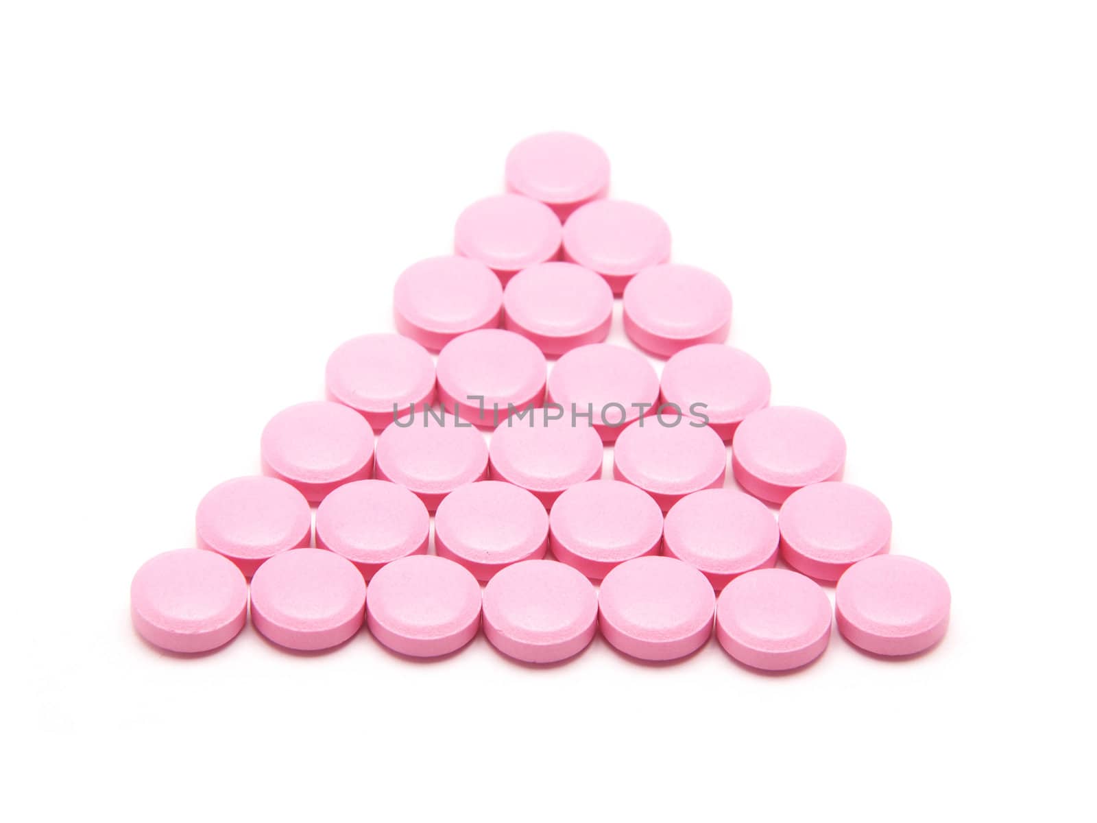 Pink tablets on a white background