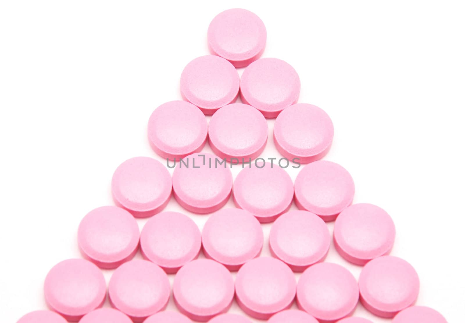 Pink tablets on a white background