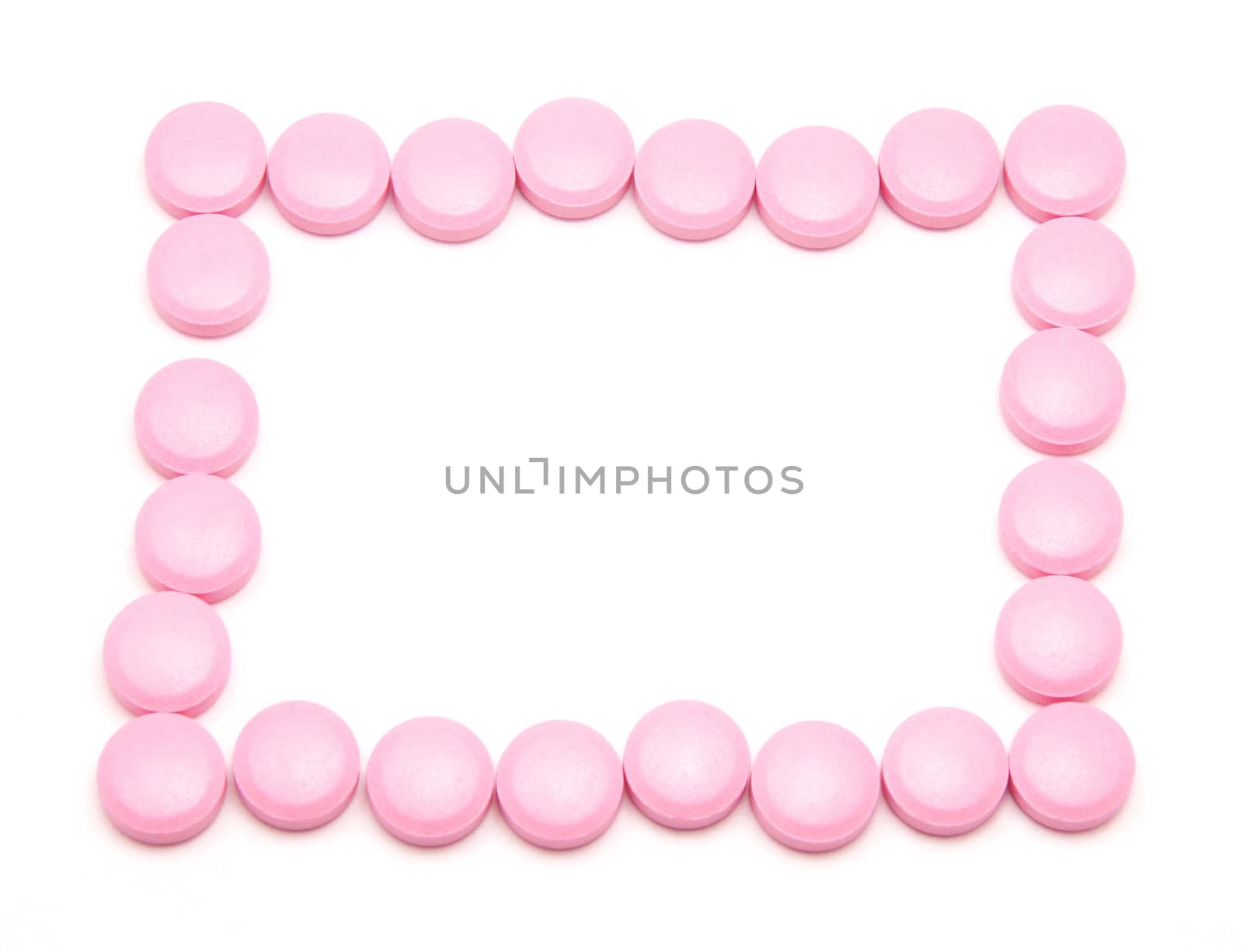 Pink tablets on a white background