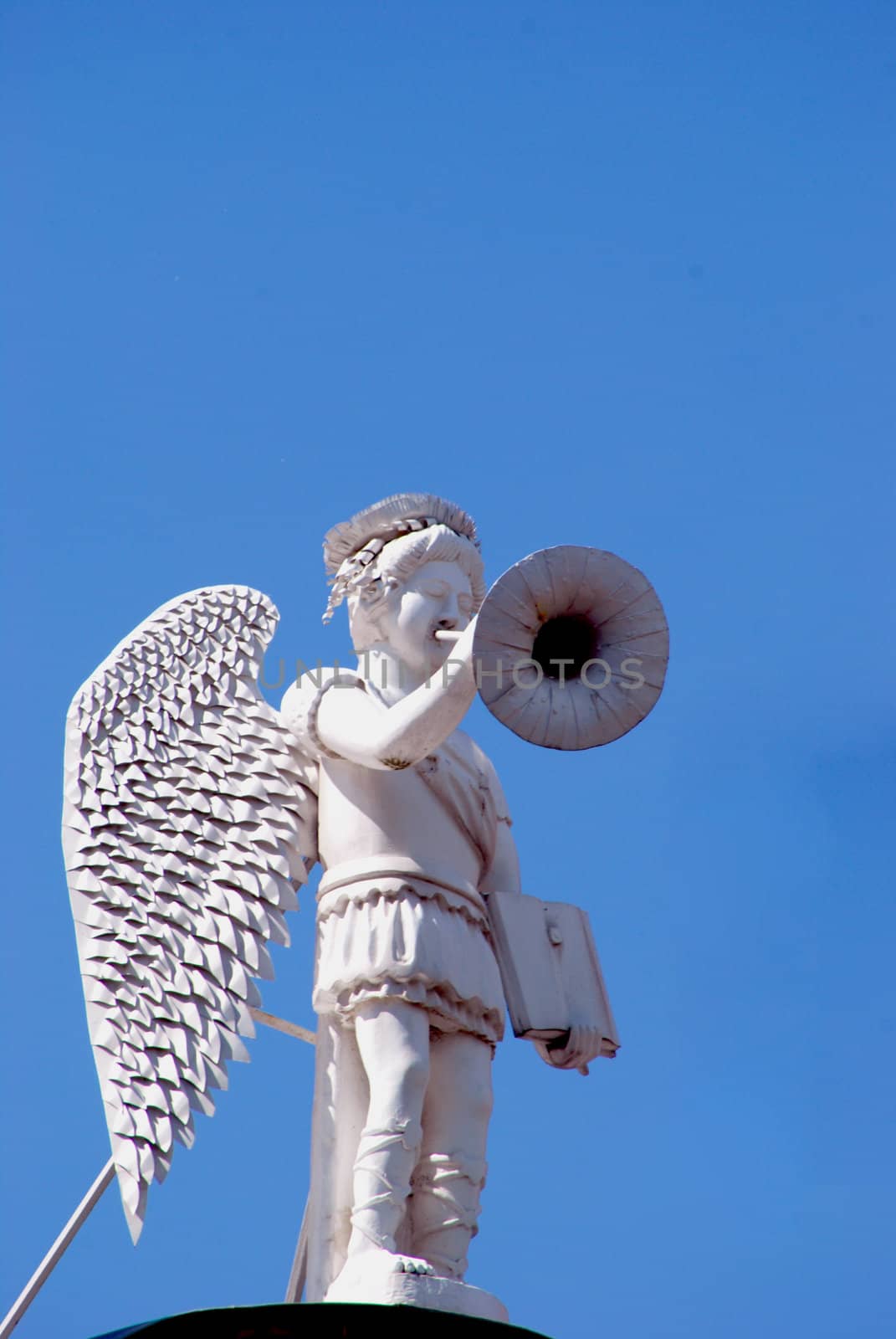 White angel with trumpet and book in hands