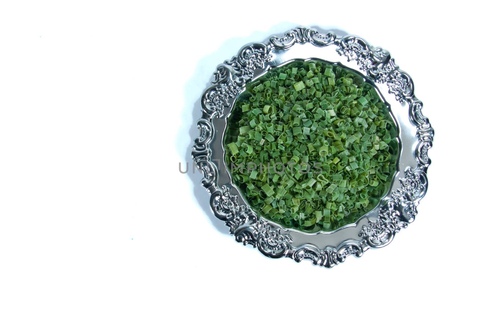 Dried chives on a silver plate by Stootsy