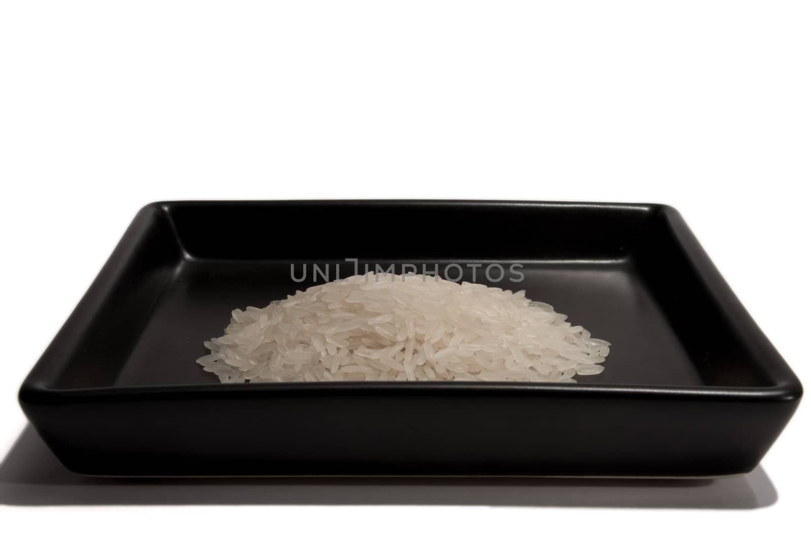 Rice on black plate by Stootsy