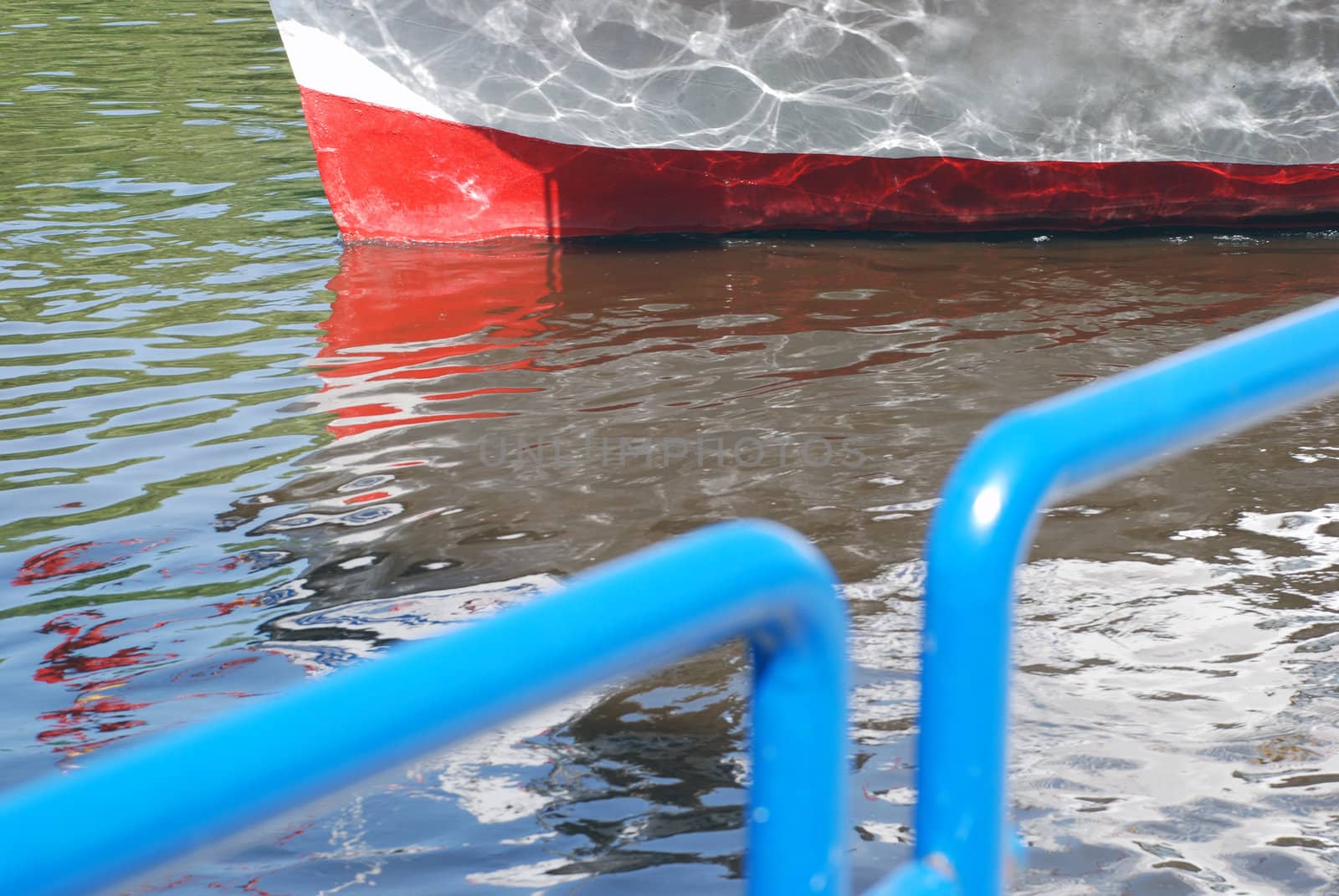 Vessel berthed at a marina in sunny day.