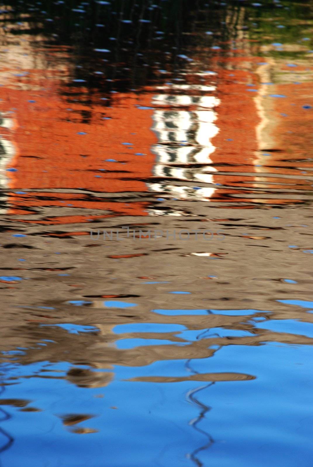 Colorful reflections in the water reminds painting stired by the wind.