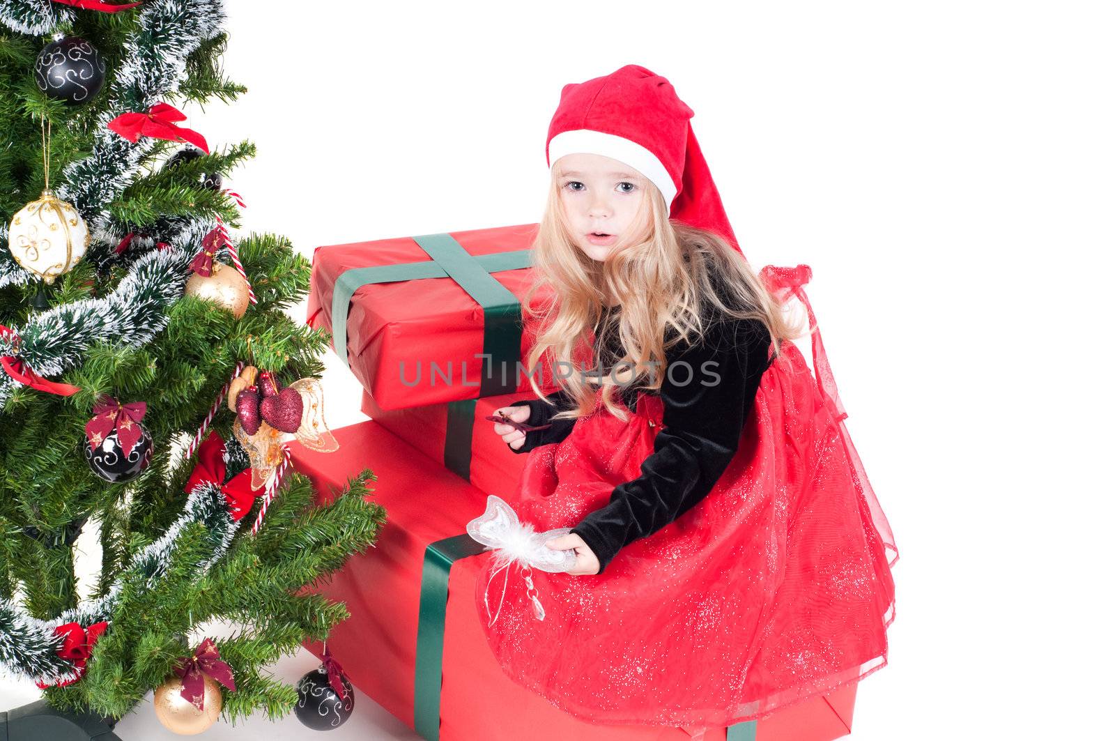 Beautiful baby girl dressed up for Christmas isolated in white