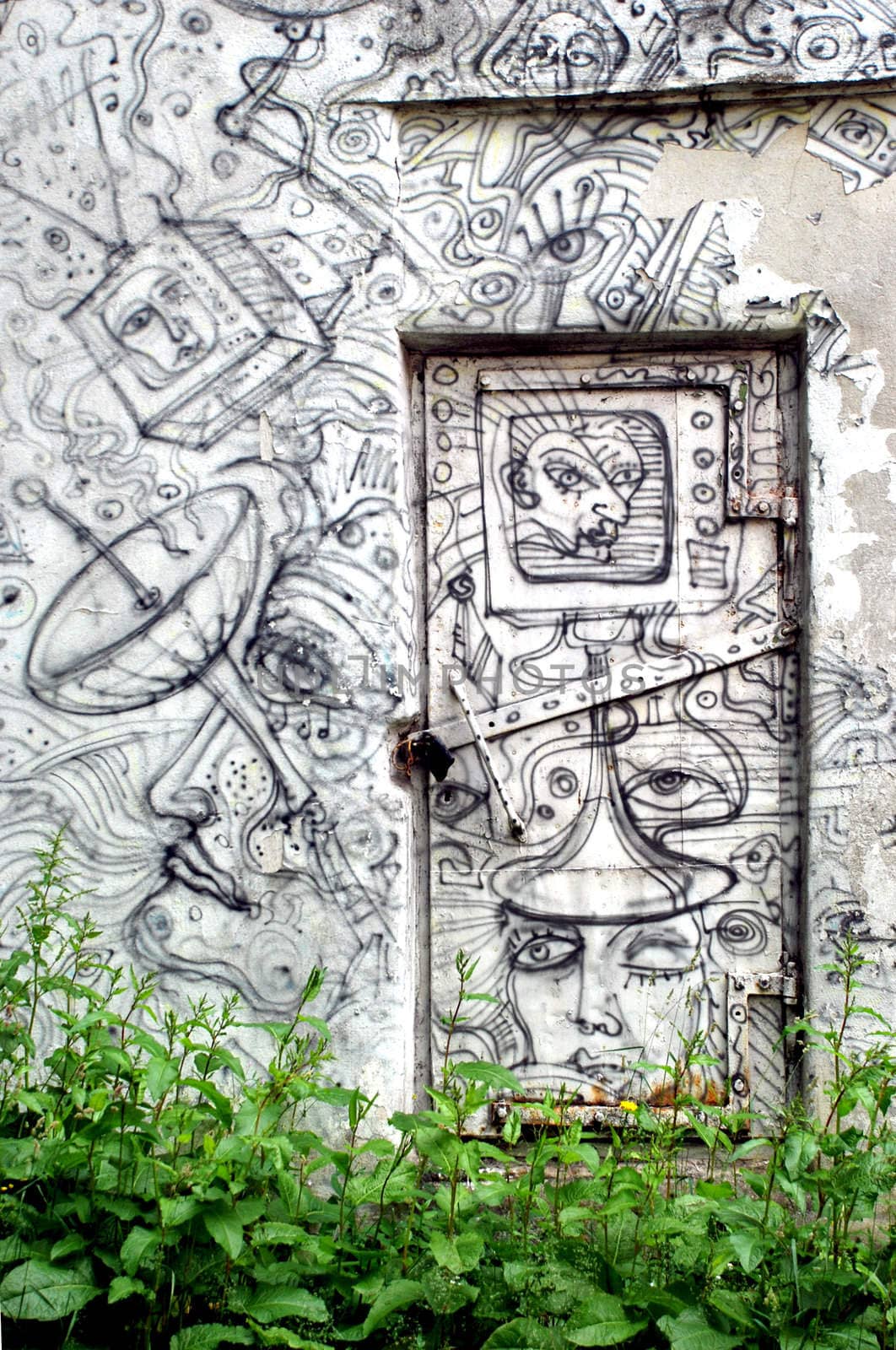 Doors and wall drawn of original rhythmic graffiti