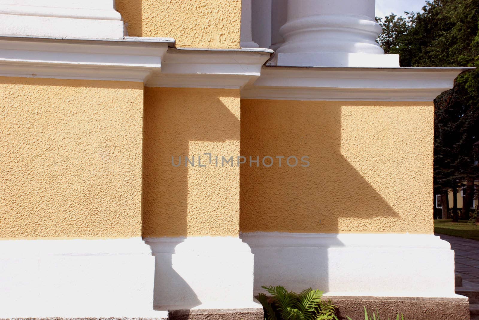 Yellow building with white colums by sauletas
