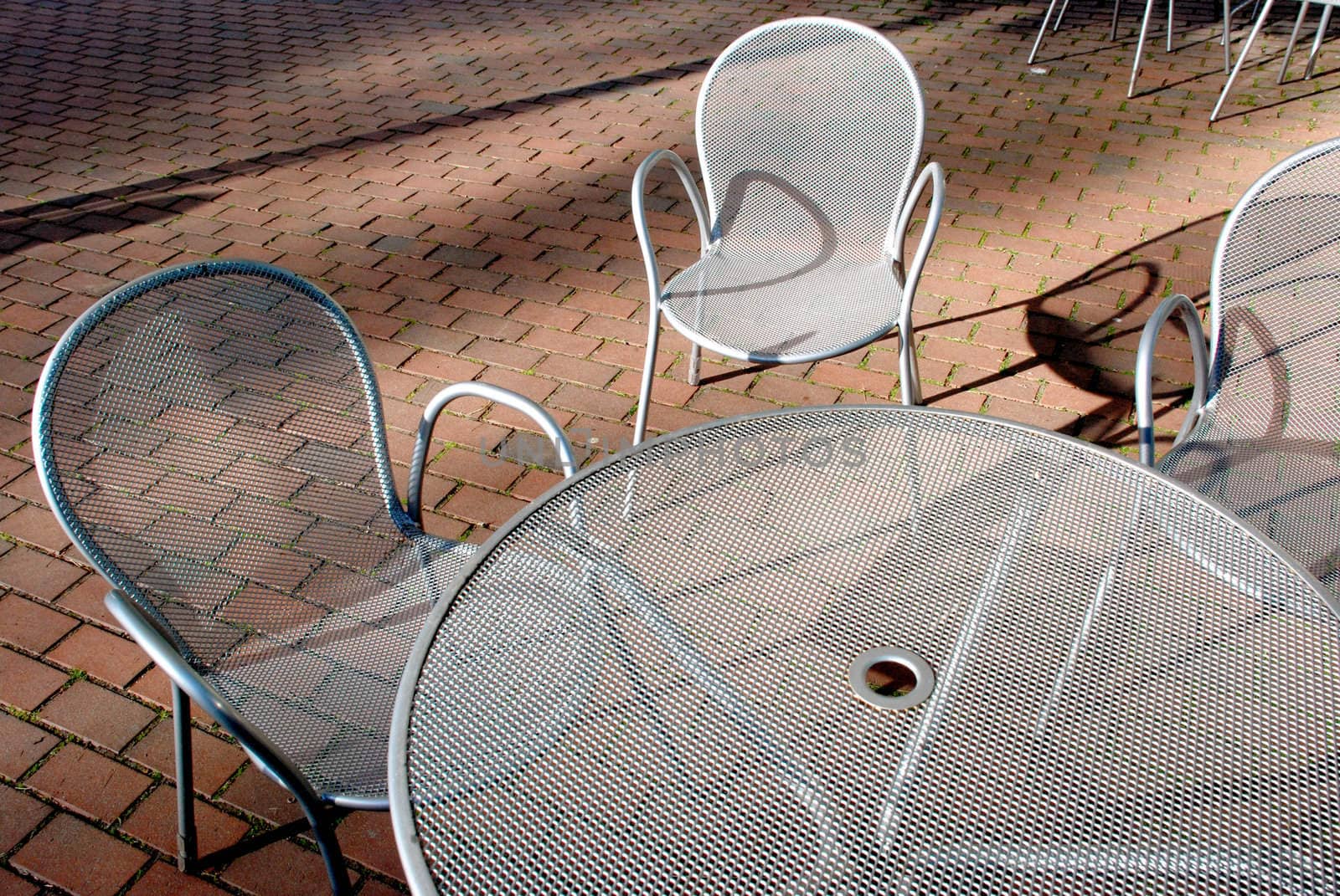 Silvery metal table and chairs by sauletas