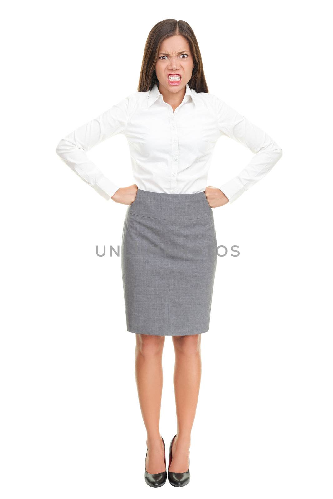 Angry upset young business woman standing isolated in full length. Funny image of mixed race Asian Caucasian female model.