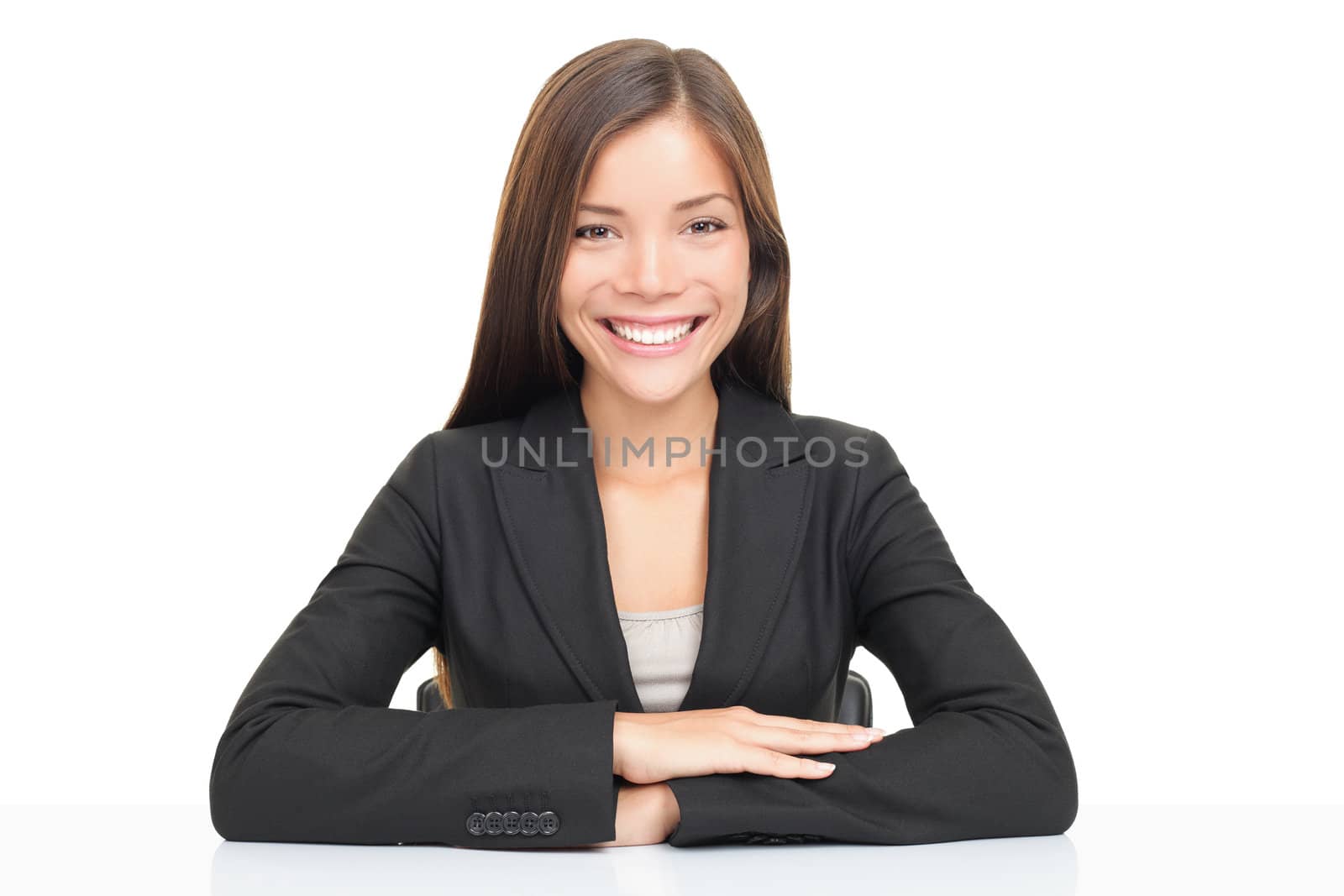 Multi ethnic businesswoman smiling sitting at her desk. Beautiful young model isolated on white background.