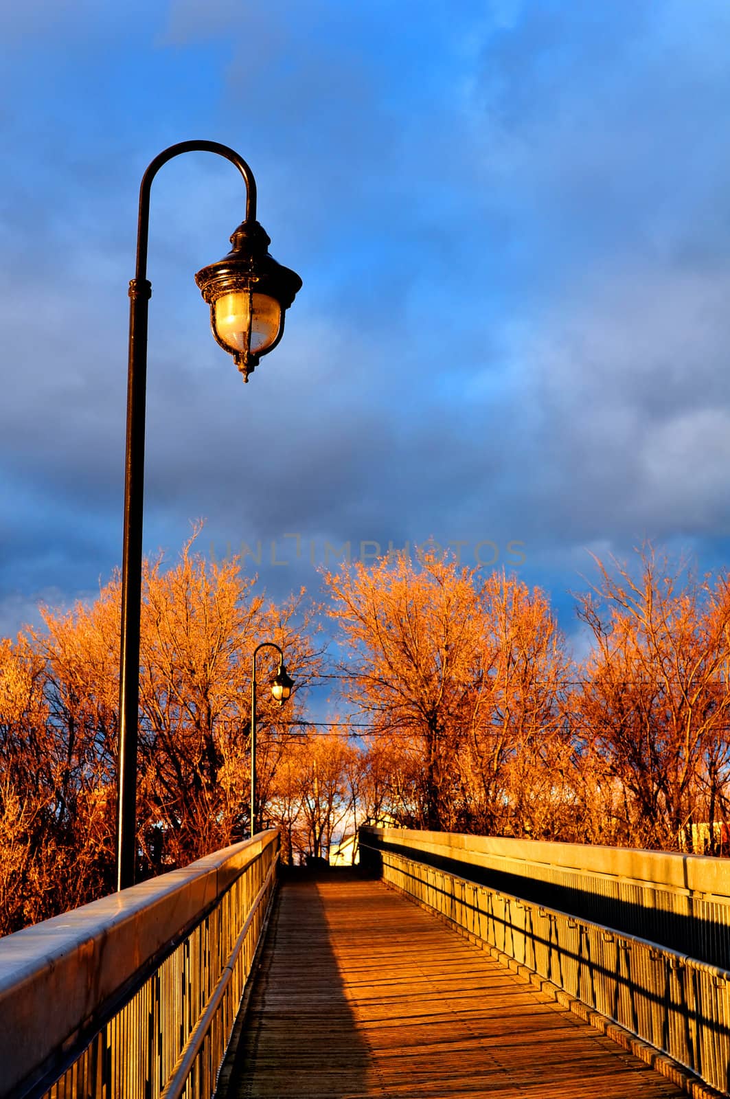 Sun setting over the wooden bridge of a small town on a autumn day.