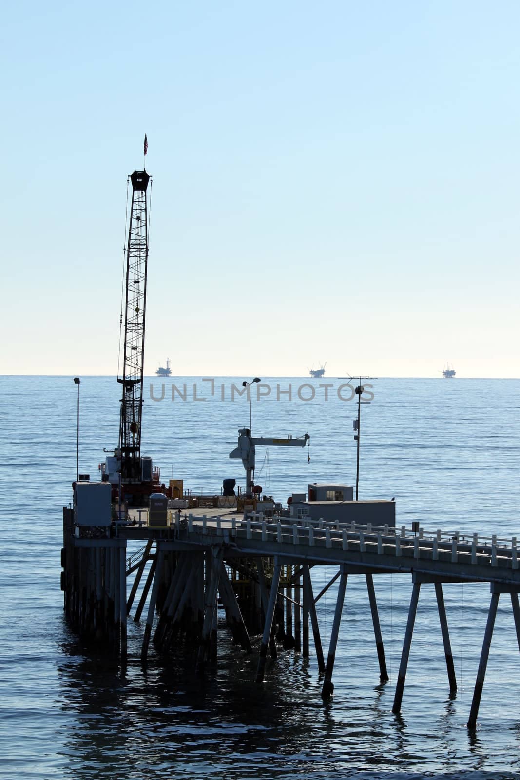 Carpinteria Pier with oil rigs at the horizon line