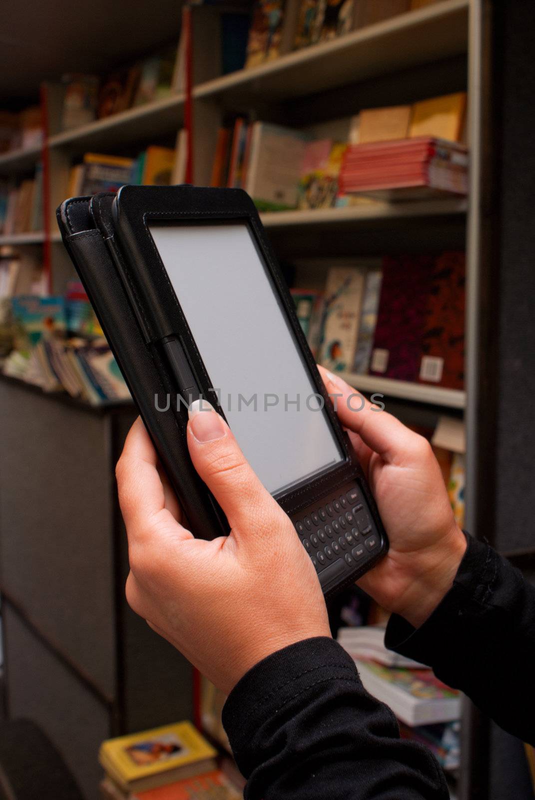 Woman's hands holding electronic book reader