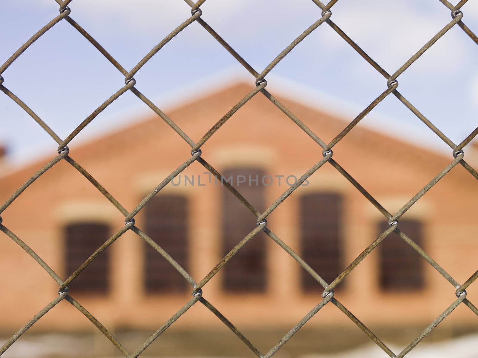Brick Wall building behind a fence