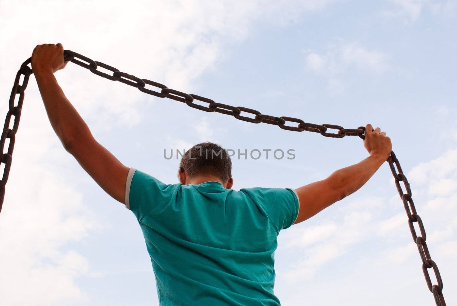 Man holding a chain against blue sky by AndreyKr