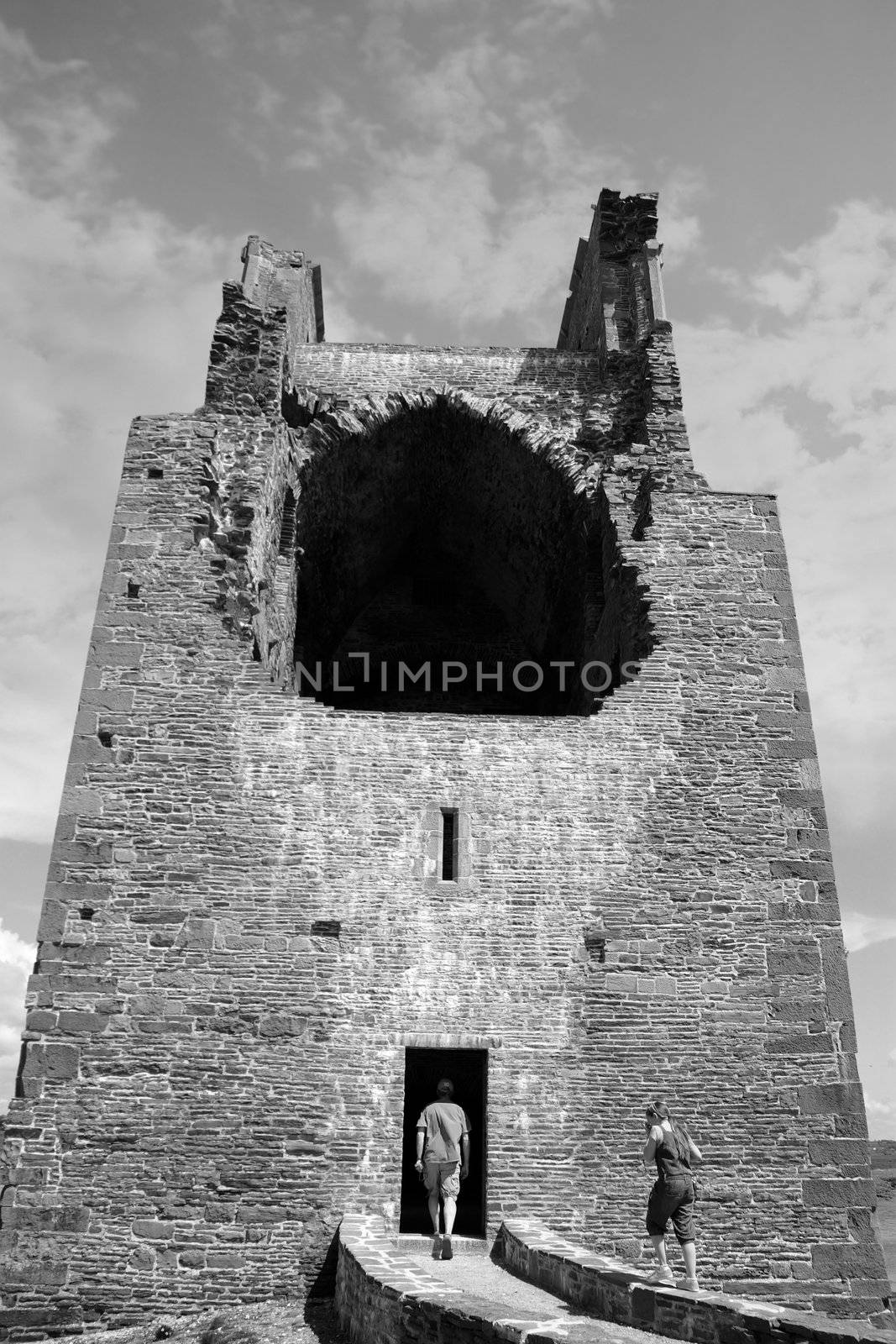 Ruins of a five-storeyed rectangular towerhouse within a bawn Partly destroyed in the 17th century in Ballylongford county kerry ireland in black and white