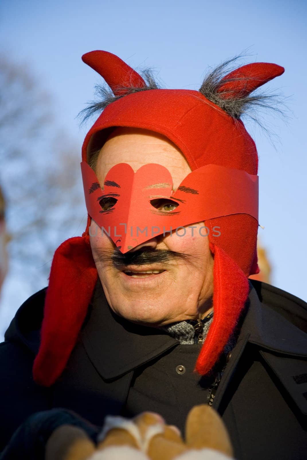 Man with red Mardi Gras celebration mask