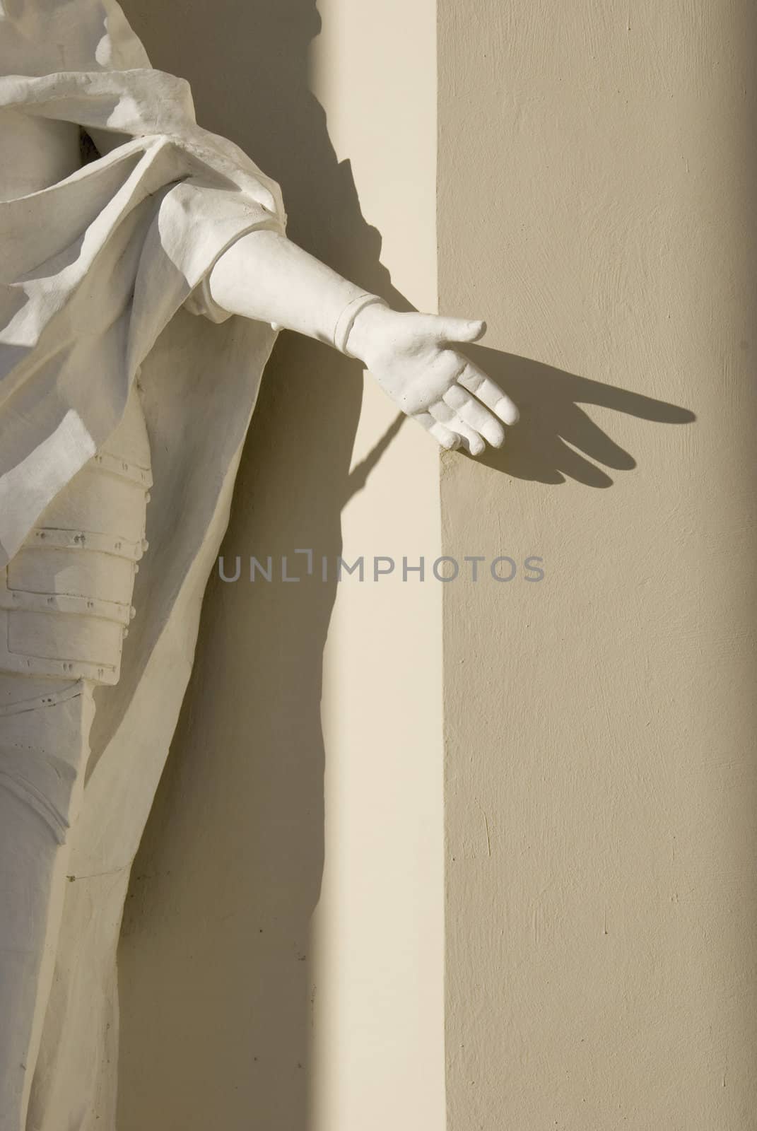 Vintage religiuos sculpture frahment with hand and shadow