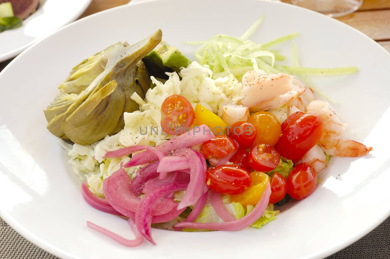 Shrimp and crab salad with tomato's, onion, artichoke, avacado, and chopped lettuce 