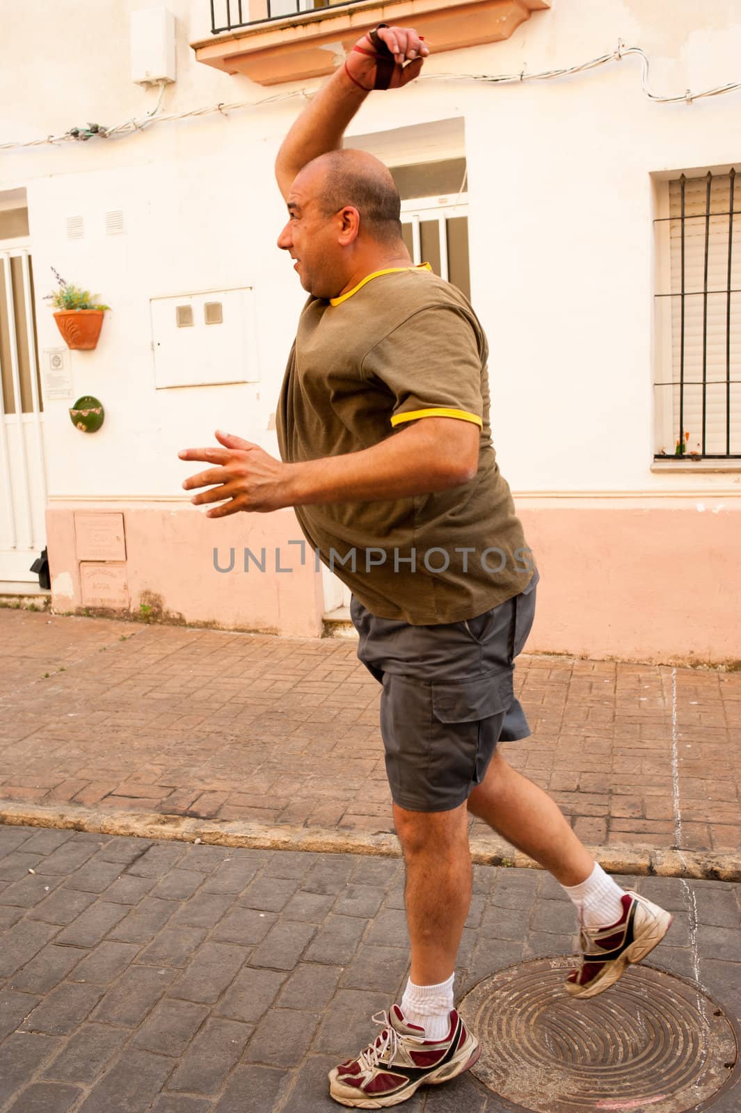 Traditional Spanish pelota player performing a serve