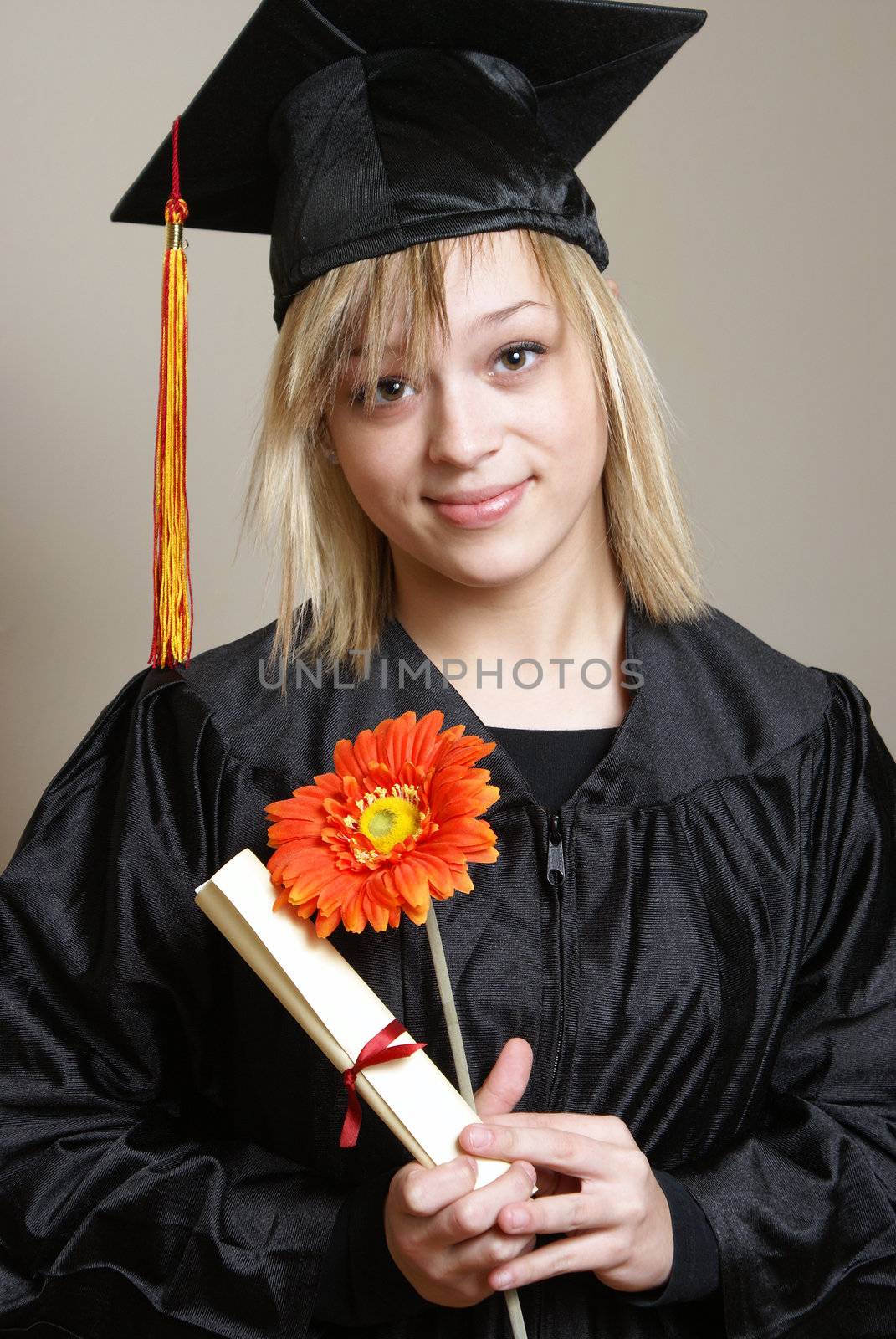 A beautiful young woman is happy to be graduating her school with a sense of an accomplishment.