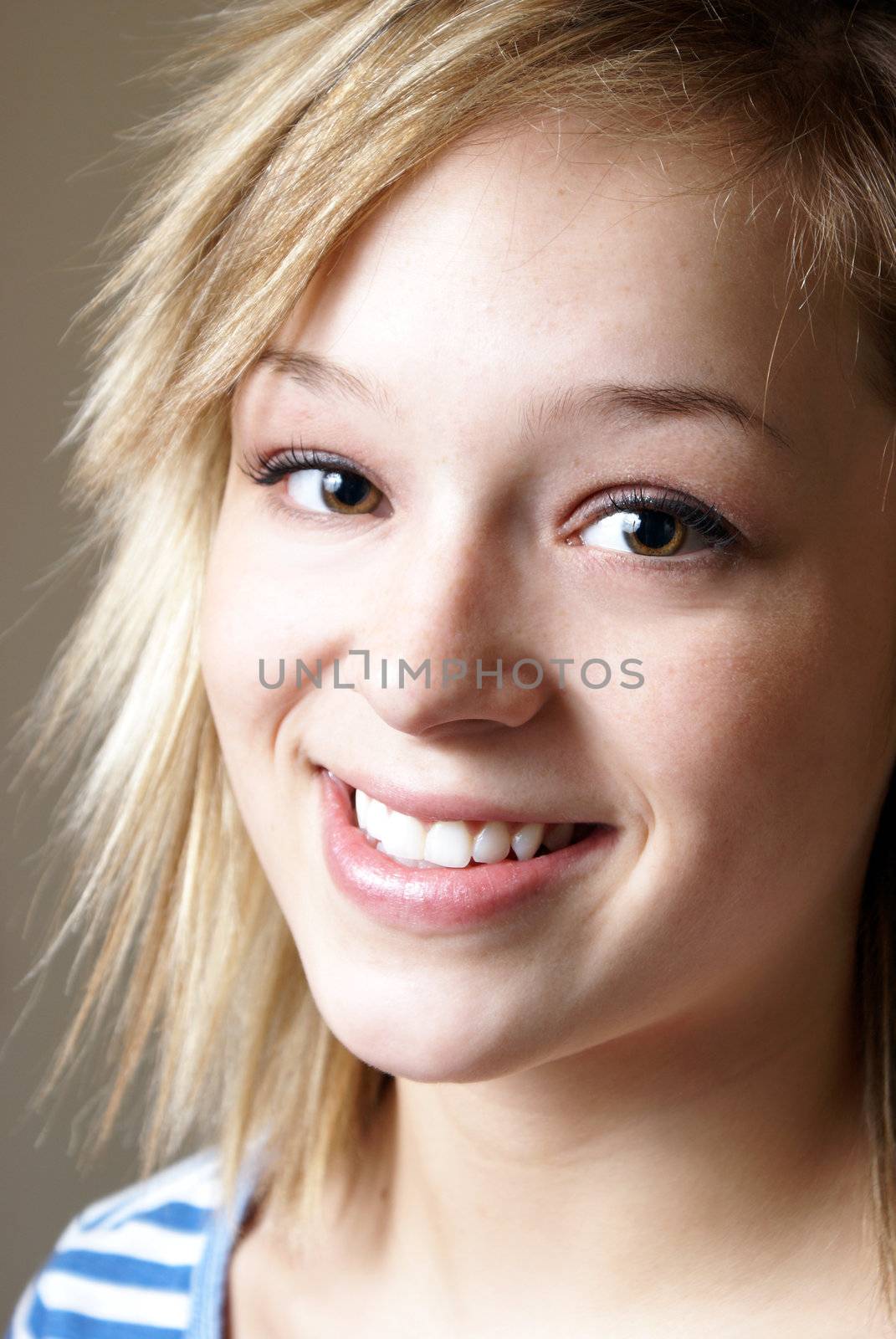 A closeup shot of a happy smiling young woman.