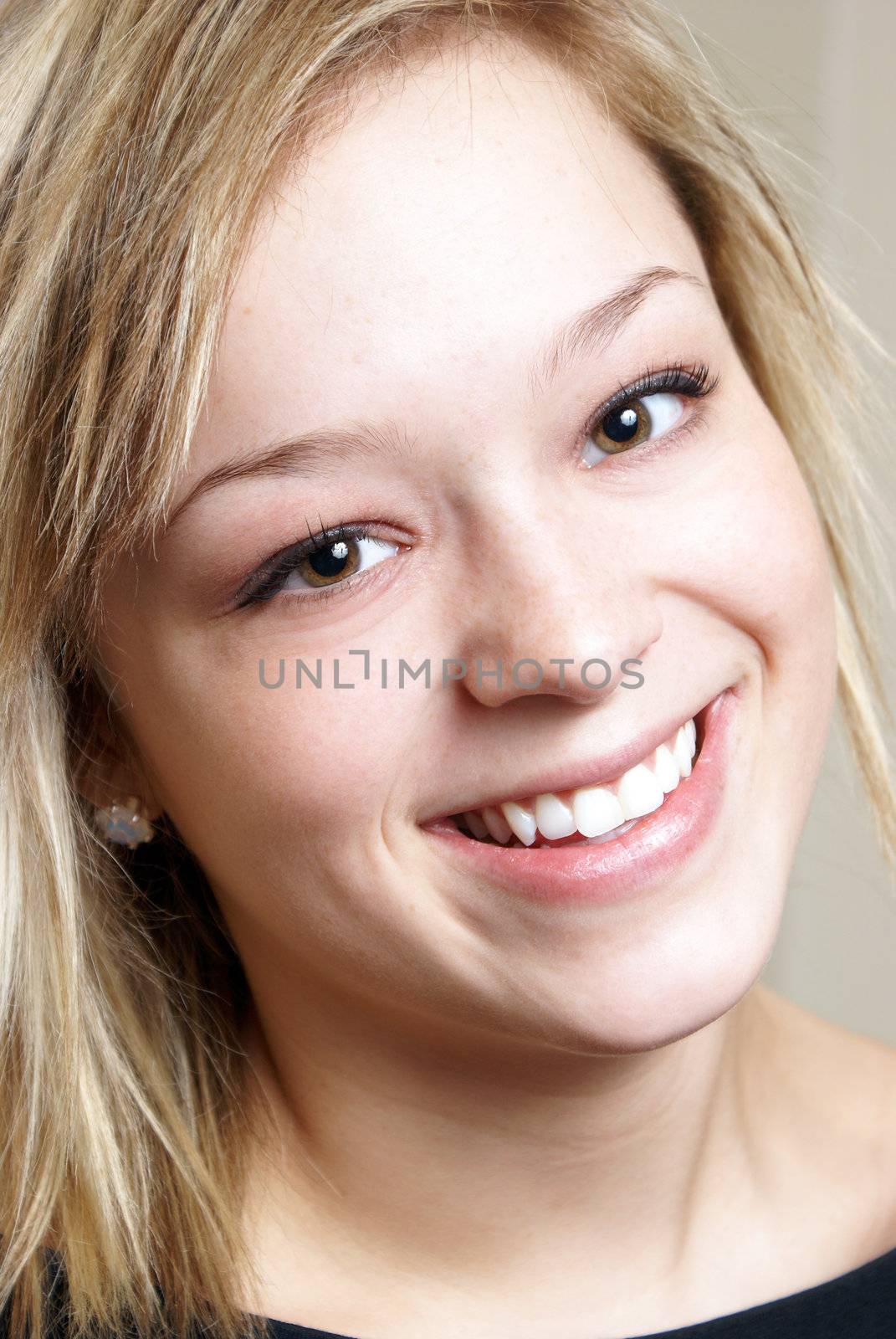 A closeup shot of a happy smiling young woman.