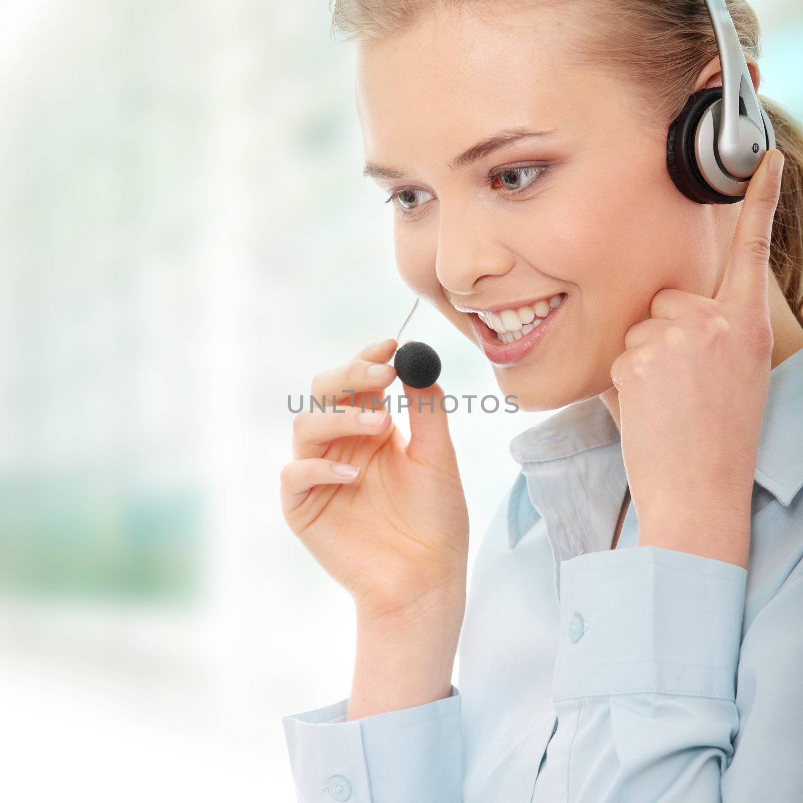 Call center woman with headset. Beautiful smiling caucasian woman