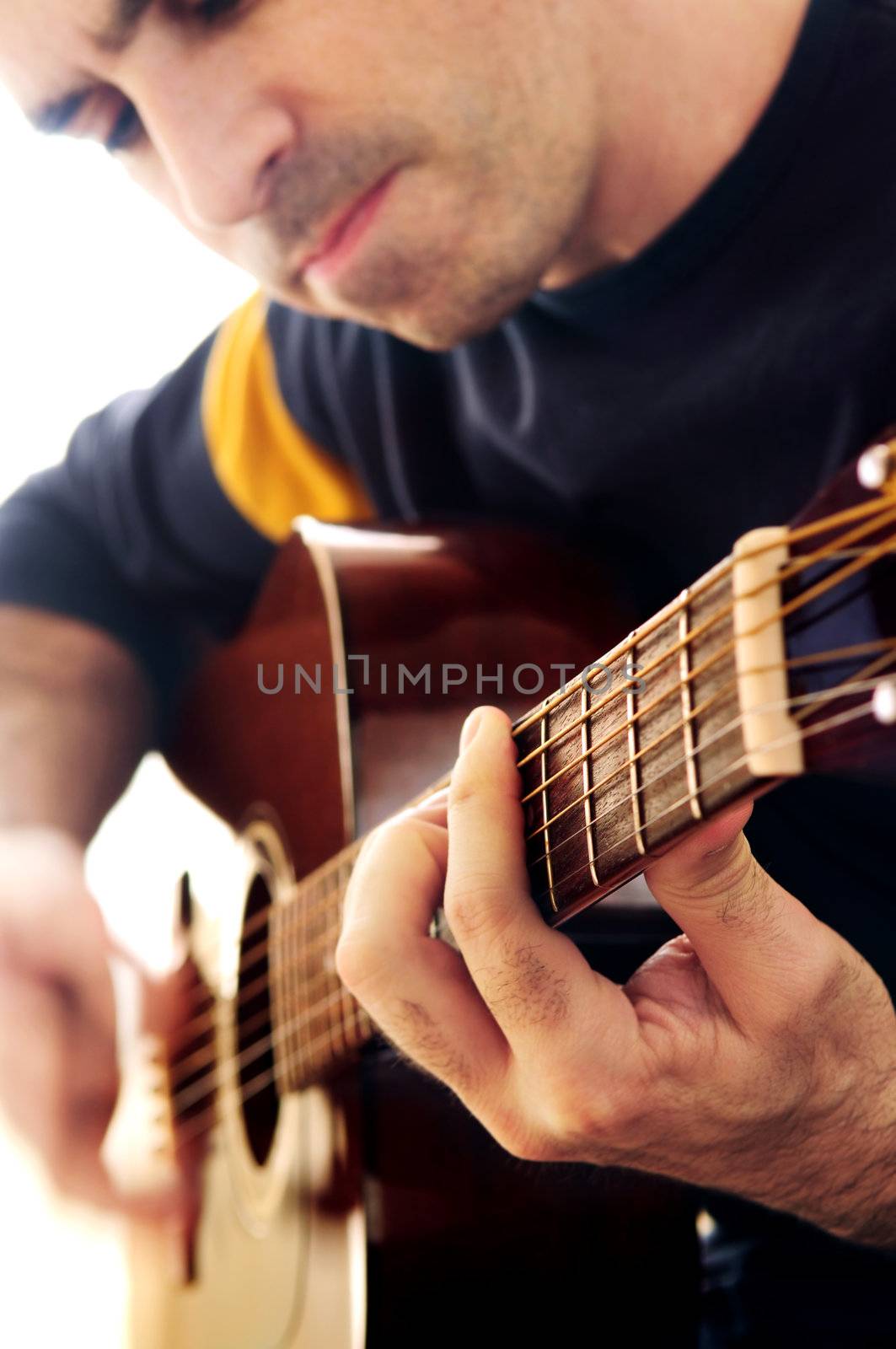 Man playing a musical instrument accoustic guitar