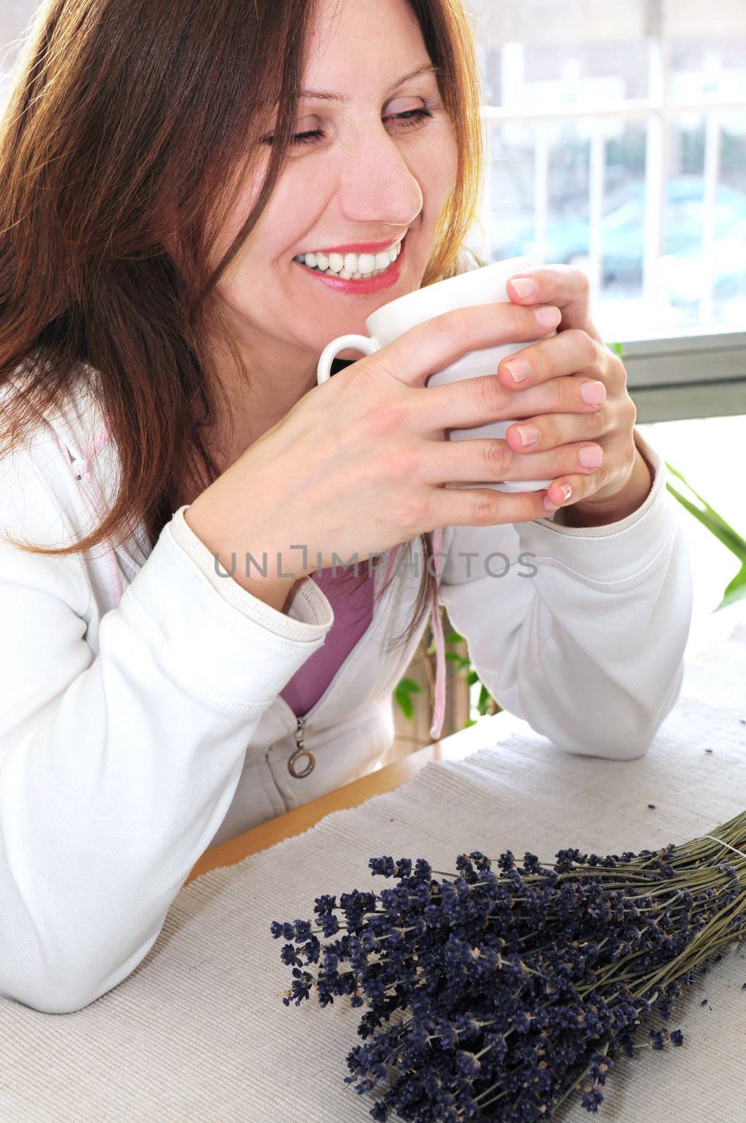 Mature woman relaxing at home holding a cup
