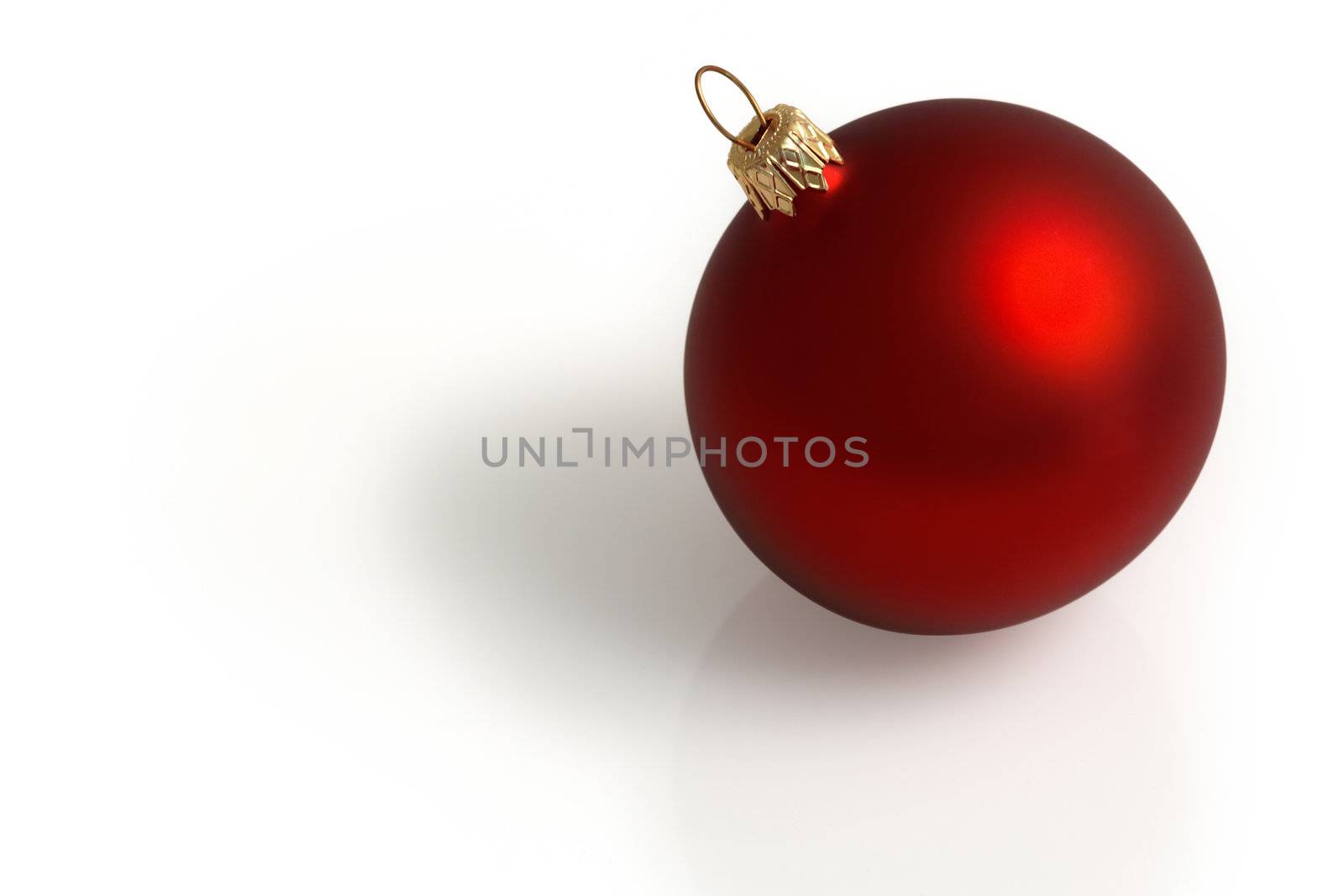 A single red Christmas ball sitting on a white background.  Clipping path included.
