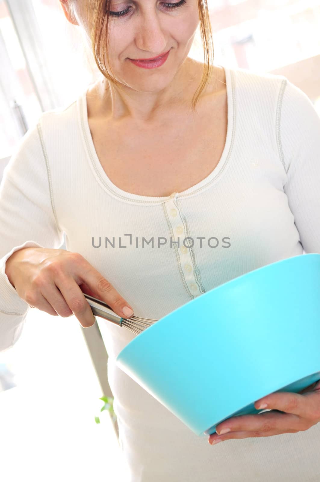 Casual mature woman enjoying cooking at home