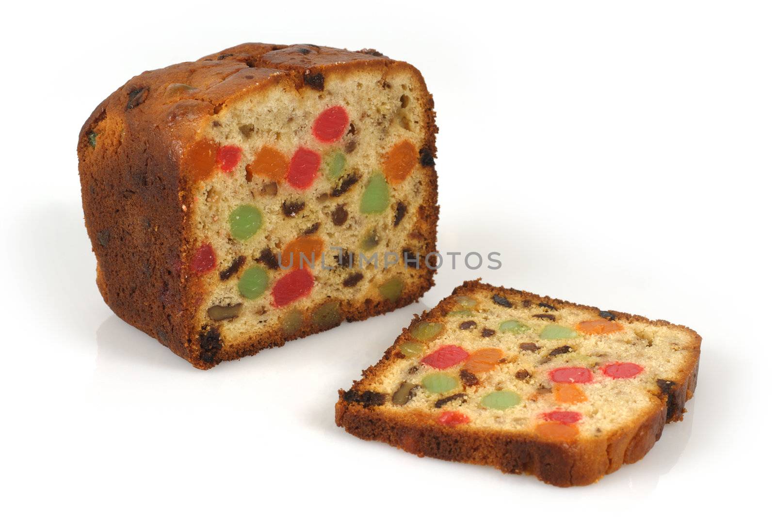 A freshly baked isolated loaf of candied Christmas fruitcake.
