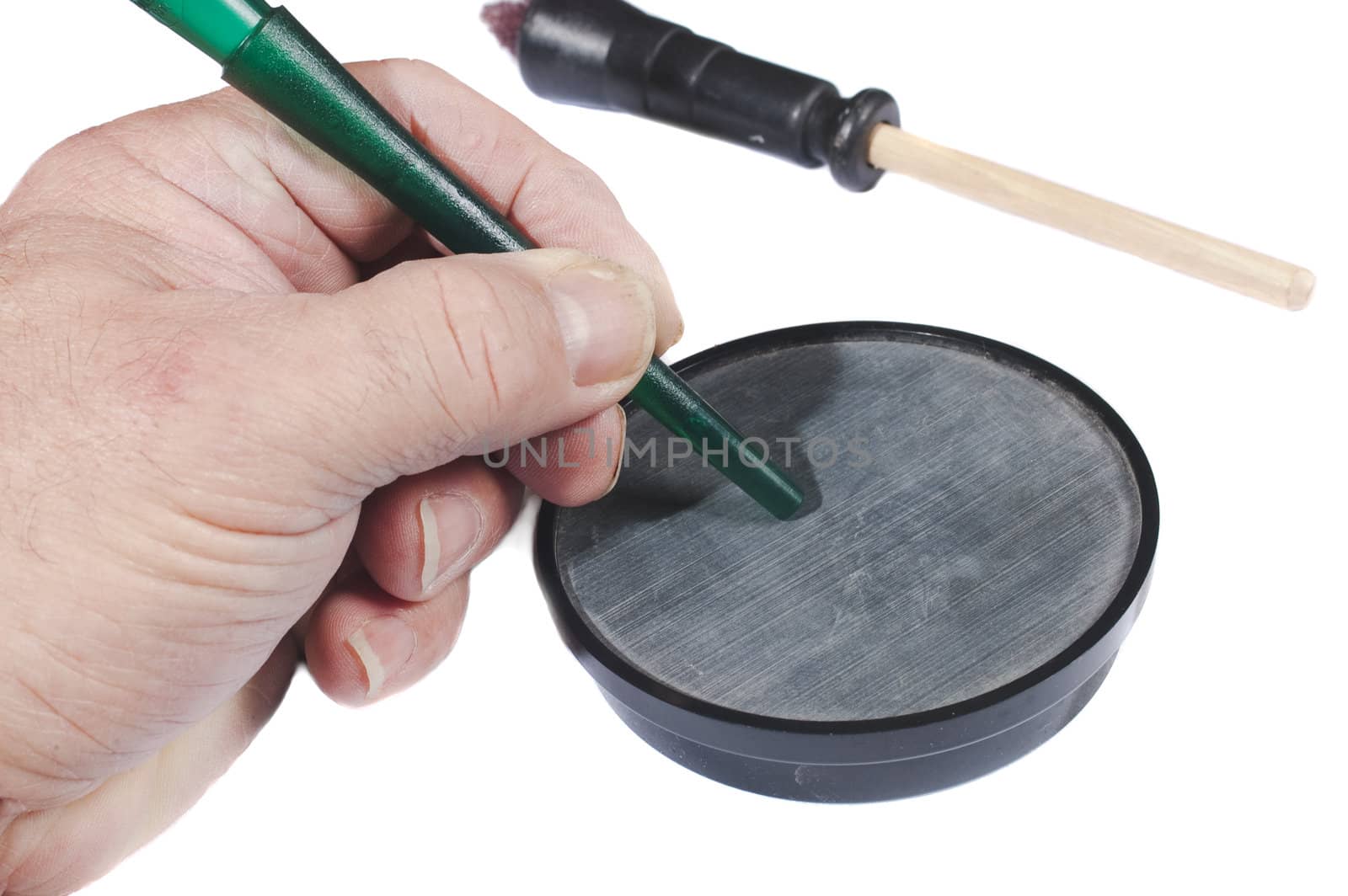 Man using a slate call simulating a hen to attract male turkeys