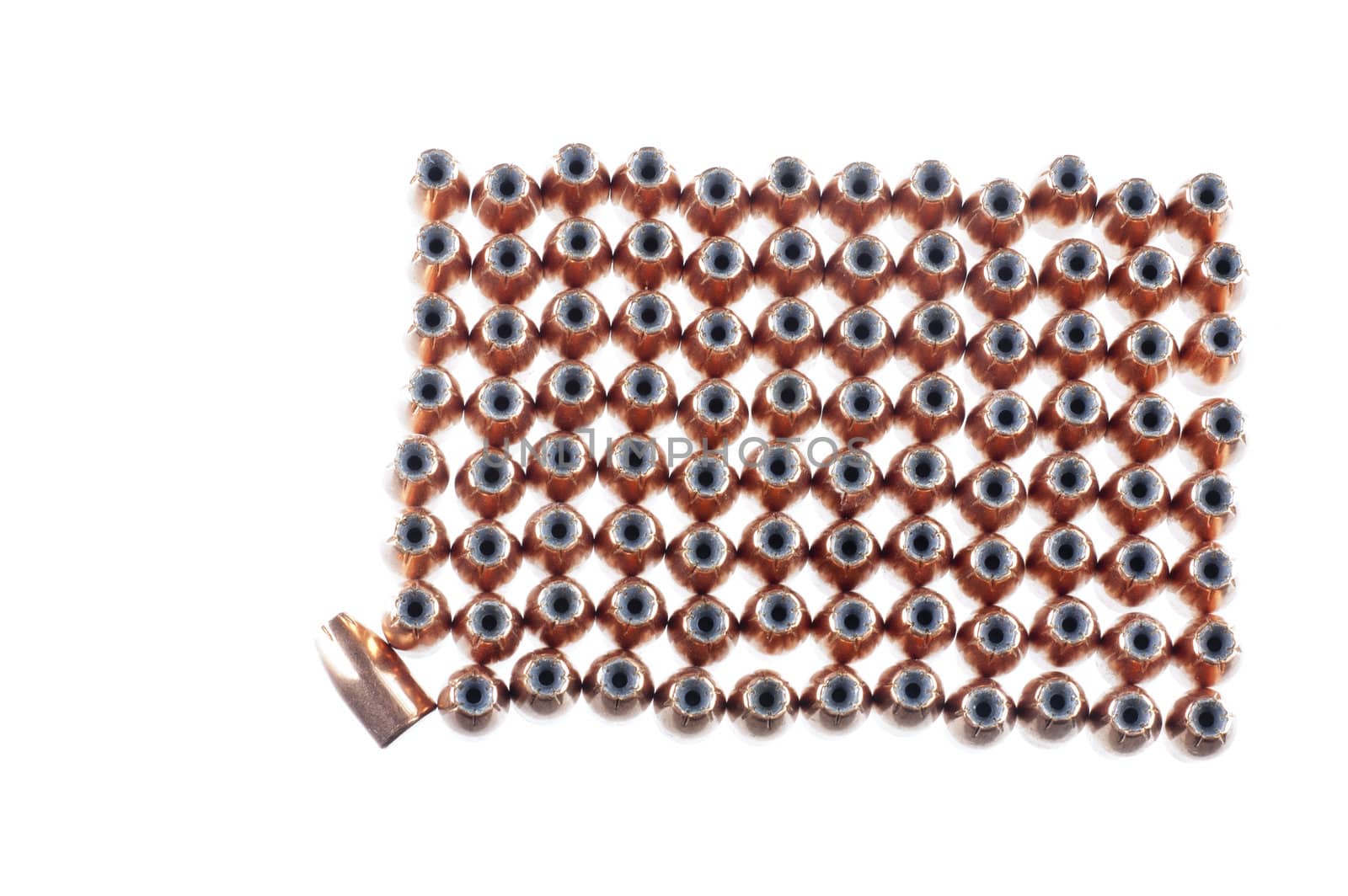 9mm hollow point bullets lined up ready for reloading, with one laying on its side as a odd man out