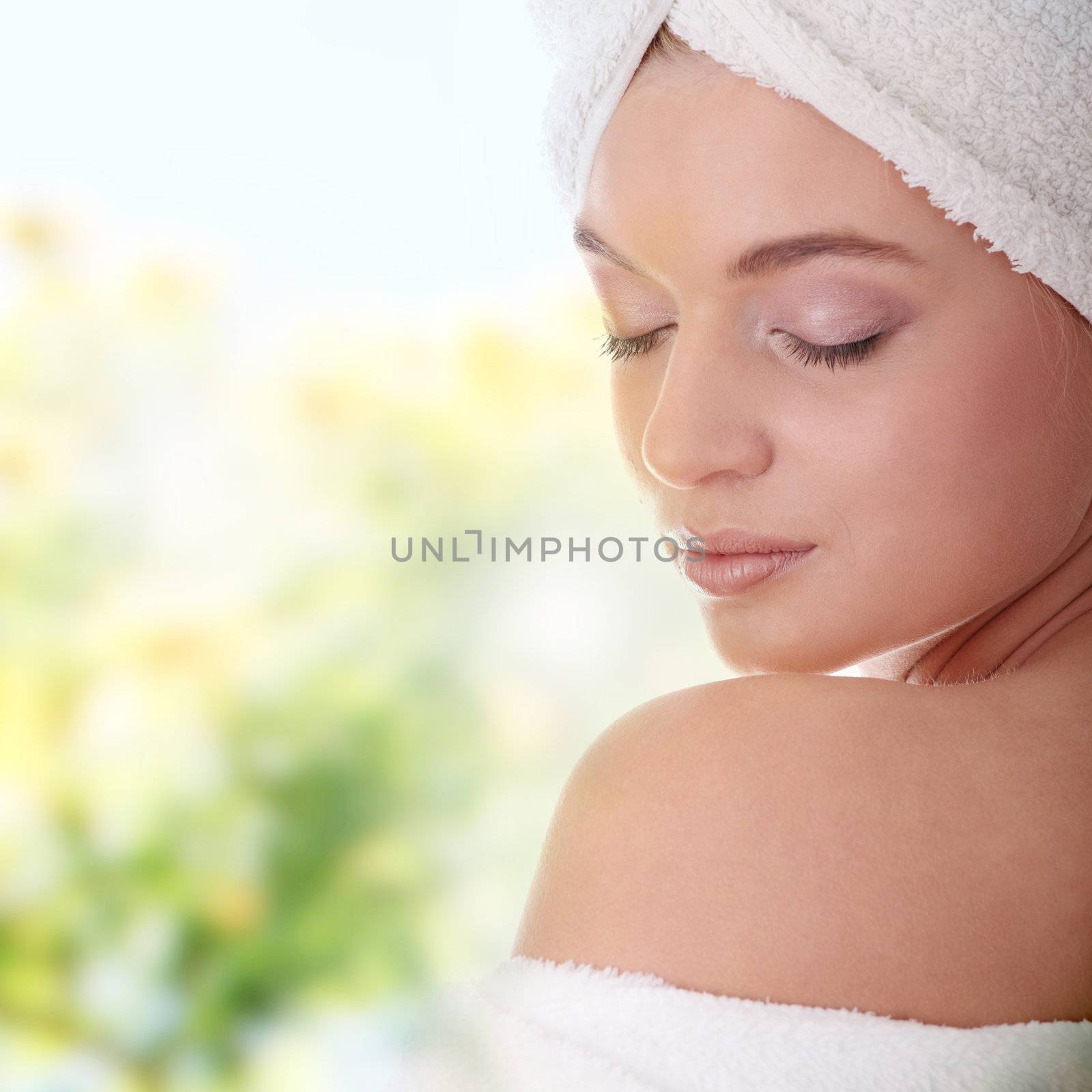 Portrait of young beautiful woman wearing bathrobe