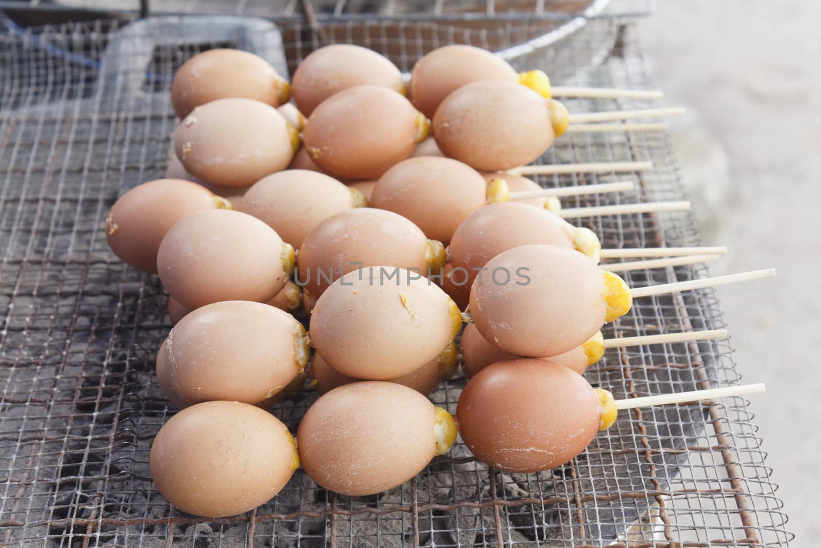 Grilled eggs on grate at market, thailand 