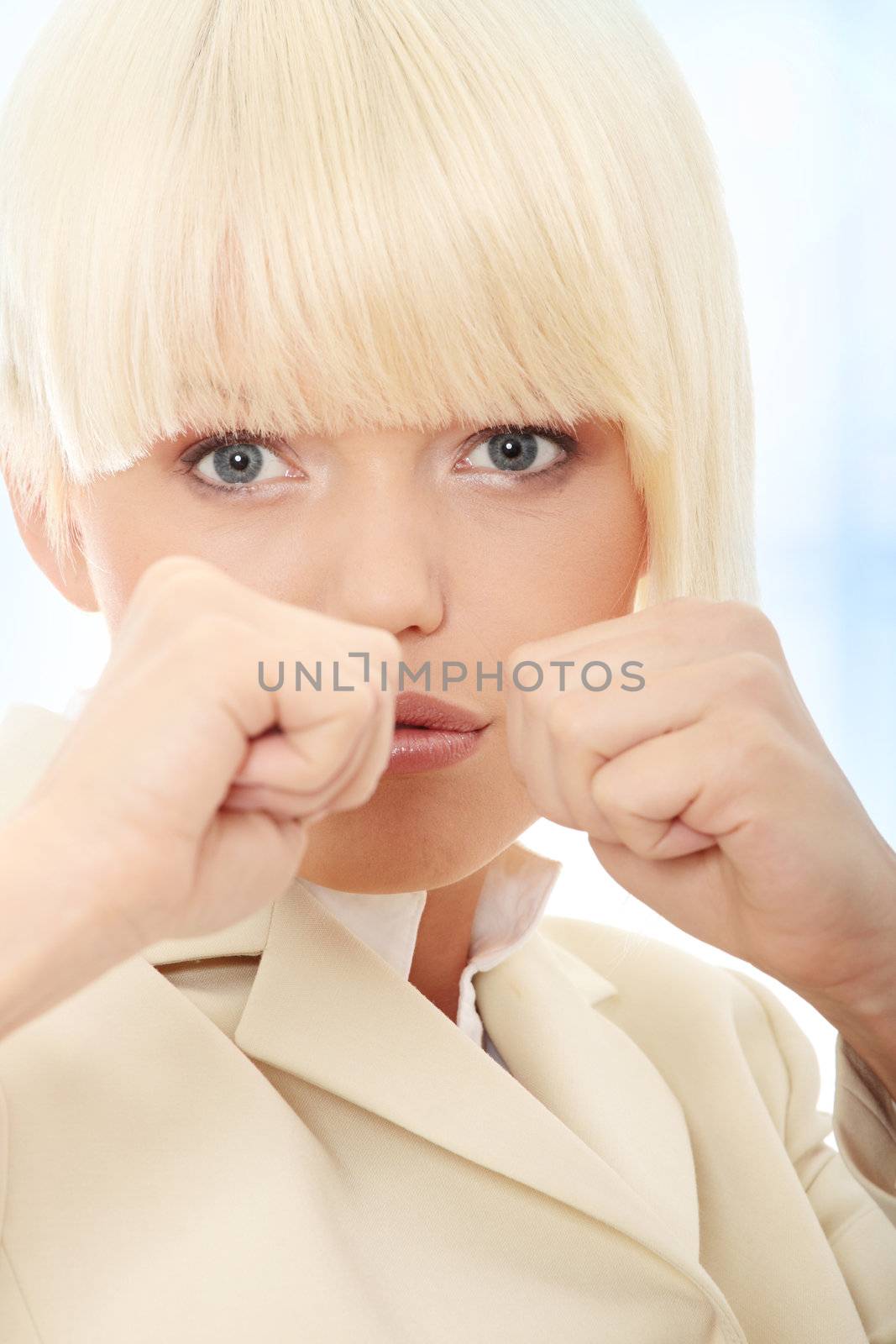Businesswoman on white getting into a fight . Over abstract blue background
