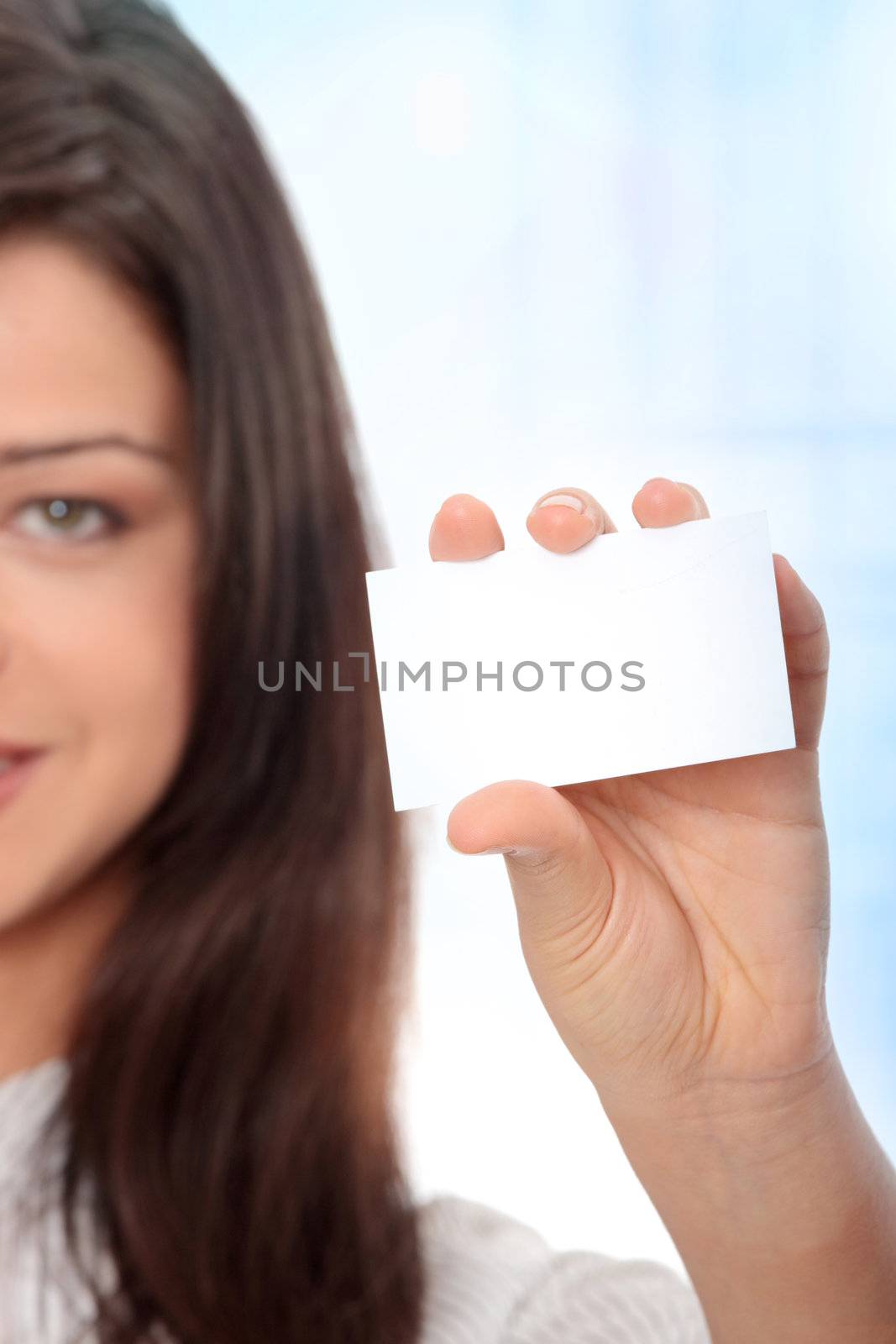 Beautiful businesswoman with business card, Over abstract blue background